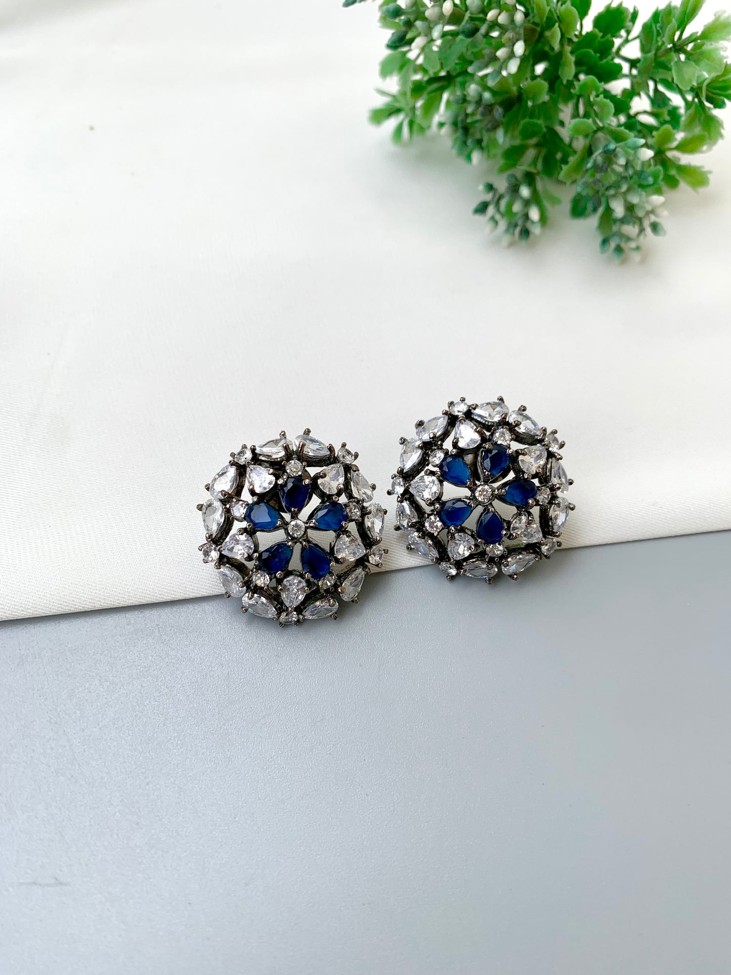 Avena handcrafted oxidized Rhodium plated stud earrings featuring American Diamonds and semi-precious Sapphire