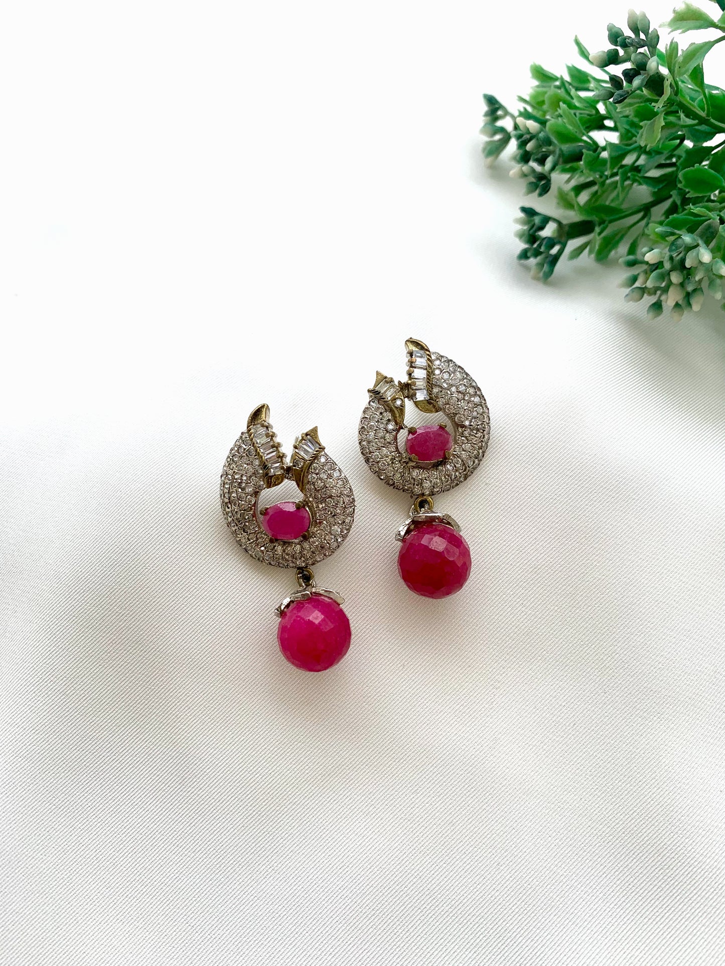 Bianca handcrafted rhodium plated earrings with a diamond finish featuring American Diamonds and semi-precious Ruby