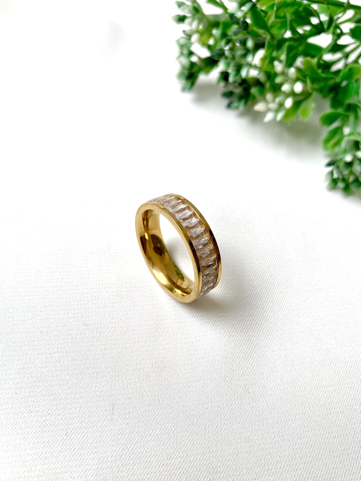 Brielle gold baguette-cut crystal band ring, 22K gold plated on 316L stainless steel by Zamal Jewels.
