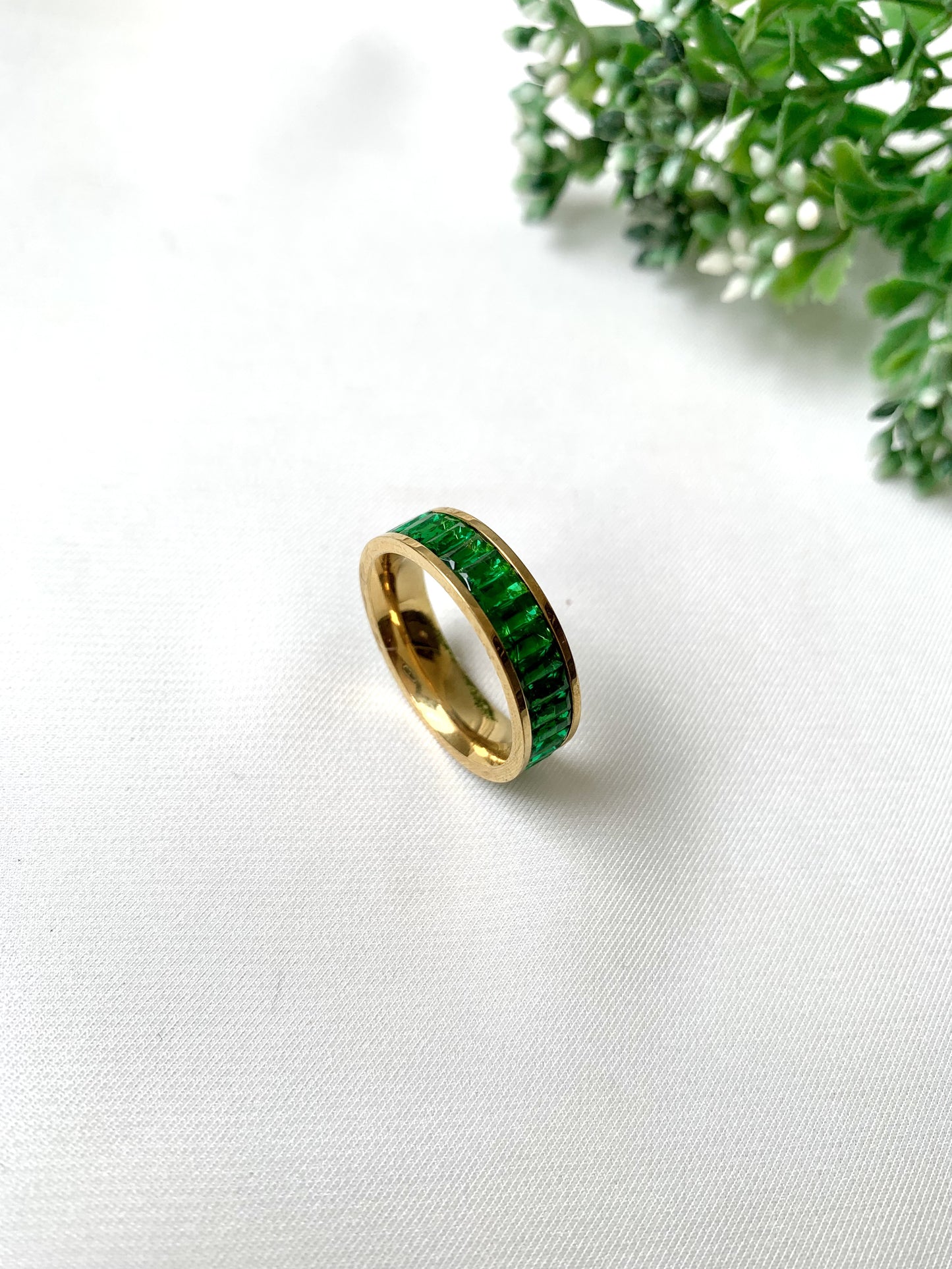 Esmera gold band ring with green baguette-cut crystals, 22K gold plated on 316L stainless steel by Zamal Jewels.