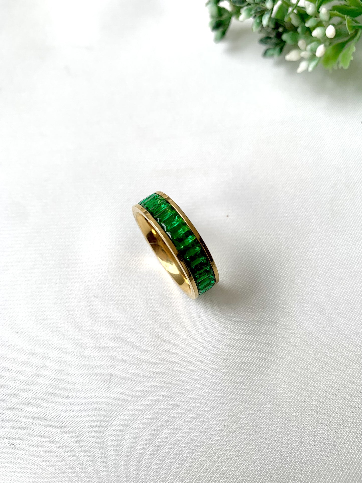 Esmera gold band ring with green baguette-cut crystals, 22K gold plated on 316L stainless steel by Zamal Jewels.