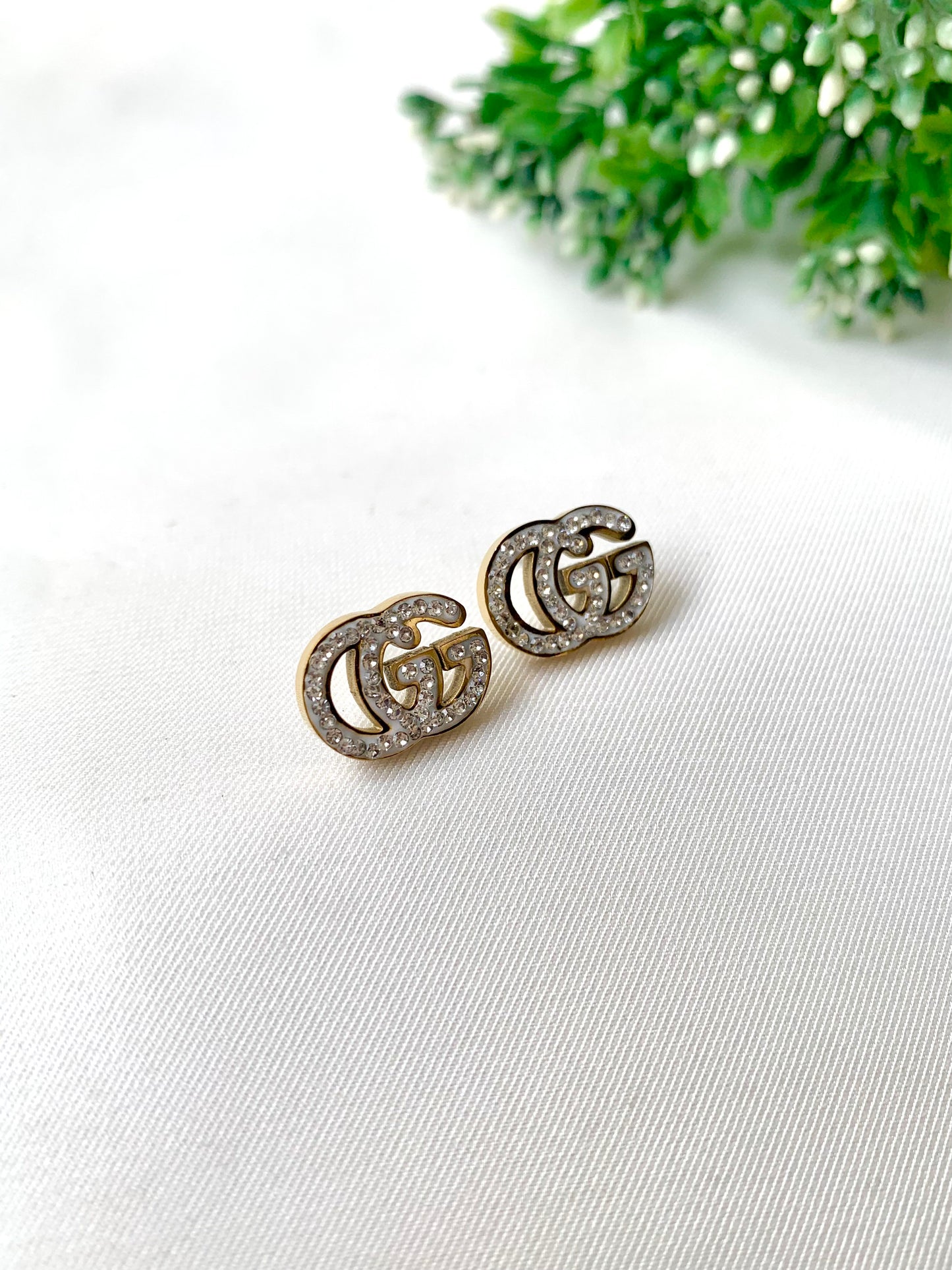 Gleia crystal gold studs with double-G design, 22K gold plated on 316L stainless steel by Zamal Jewels.
