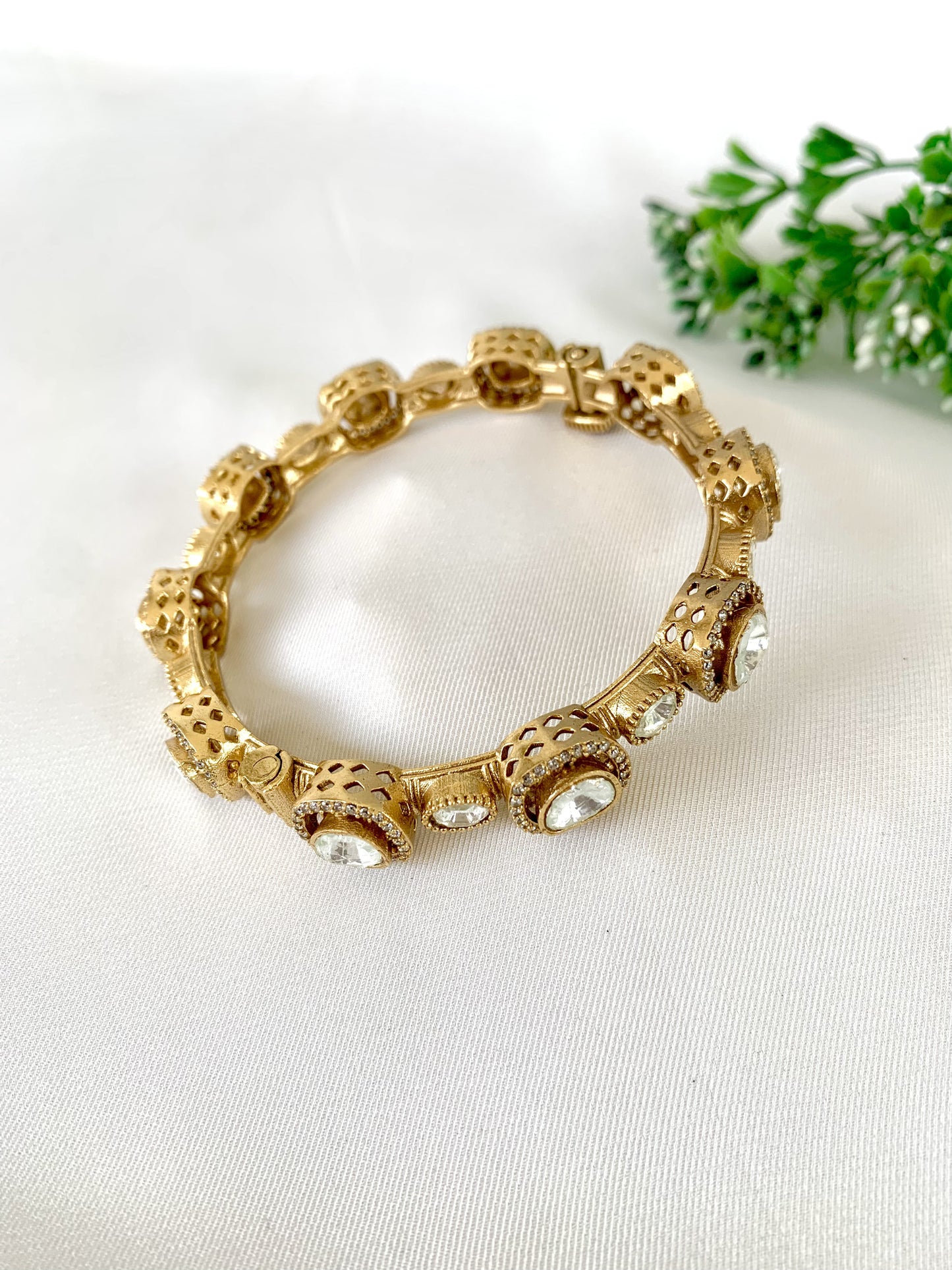 High-end traditional bangle with sparkling kundan and gold finish