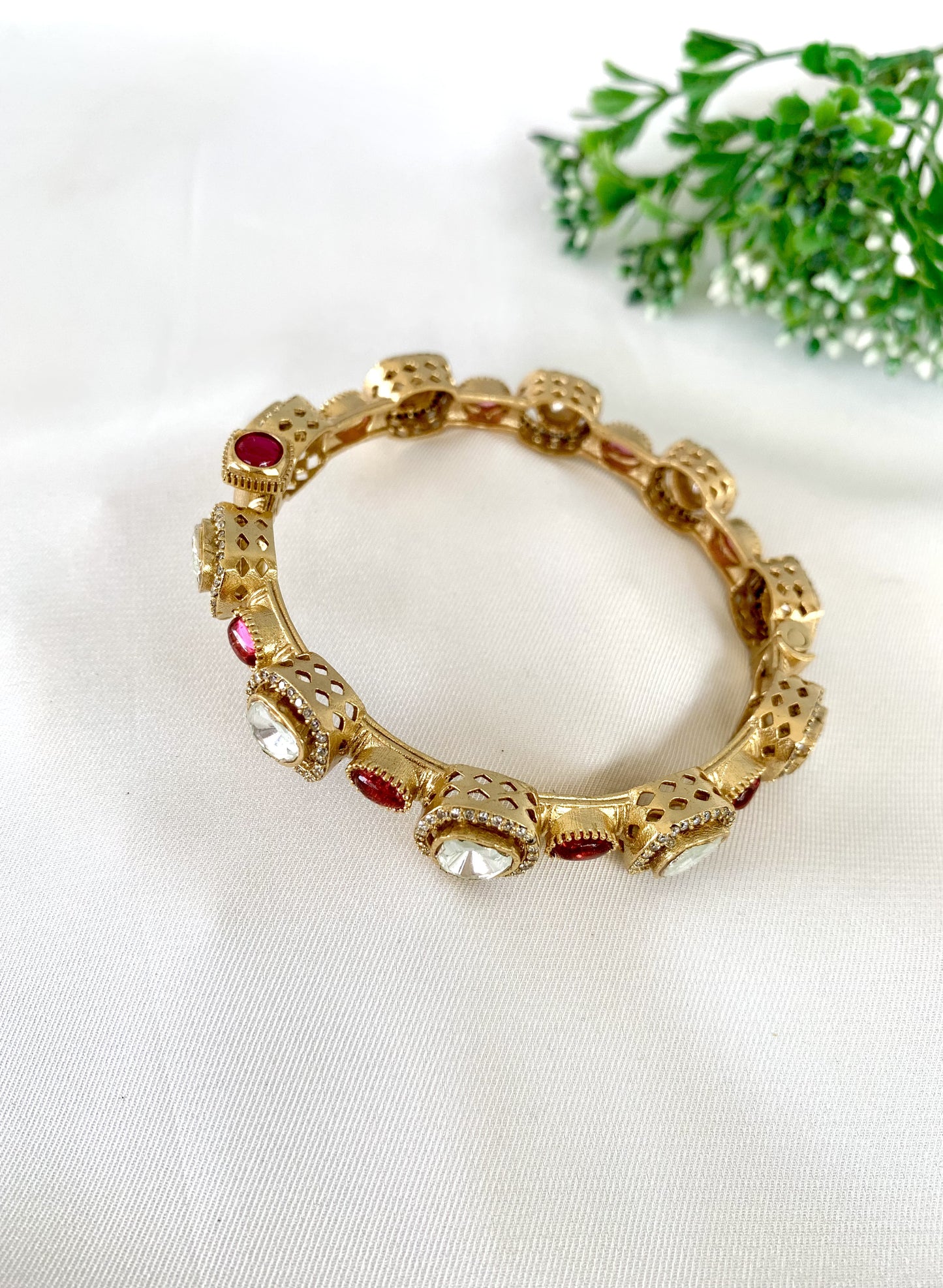 Red gemstone bangle with kundan and diamond accents