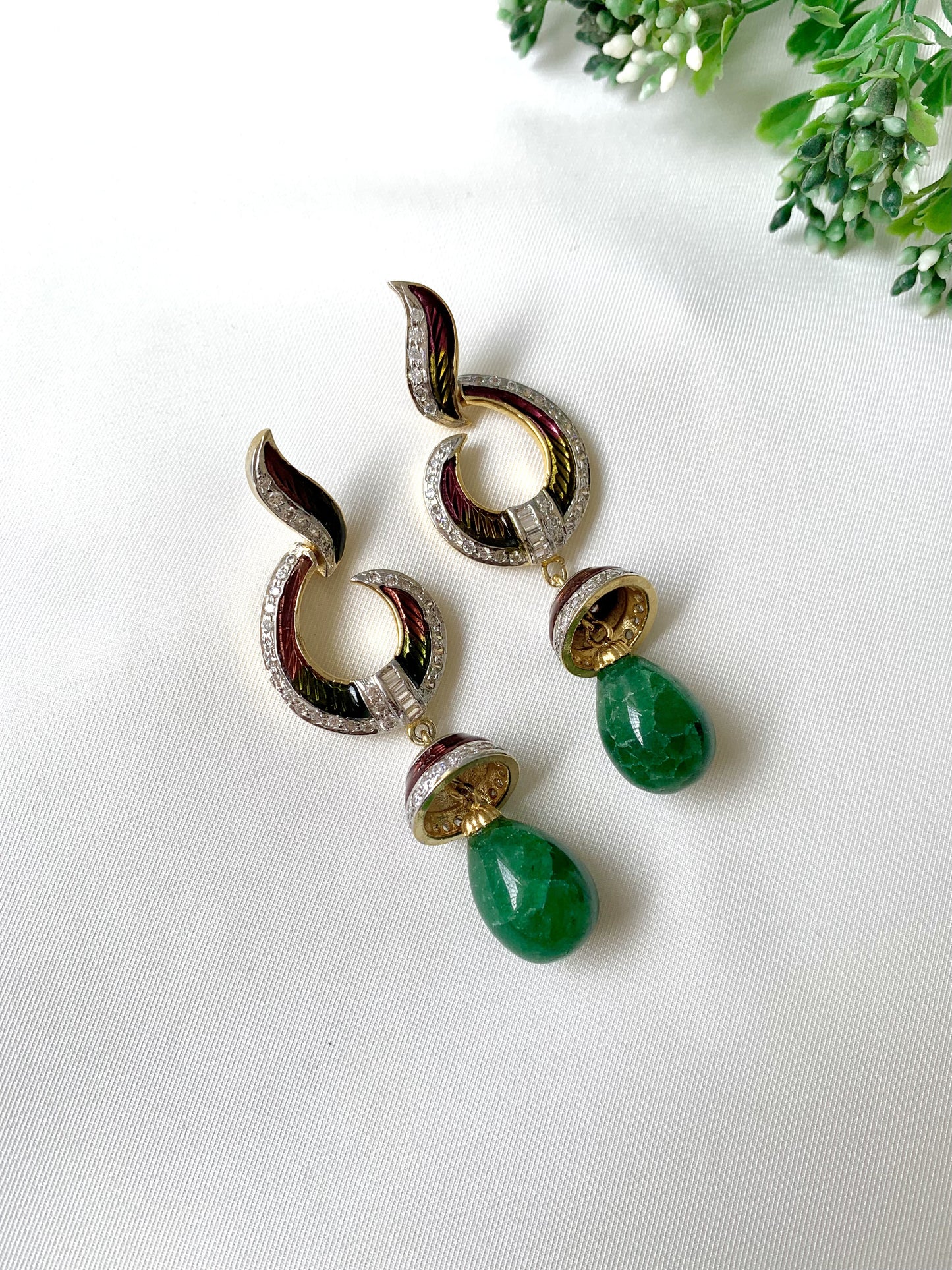Handcrafted emerald jhumka earrings with American Diamonds and hand-painted Meena detailing in gold-tone finish