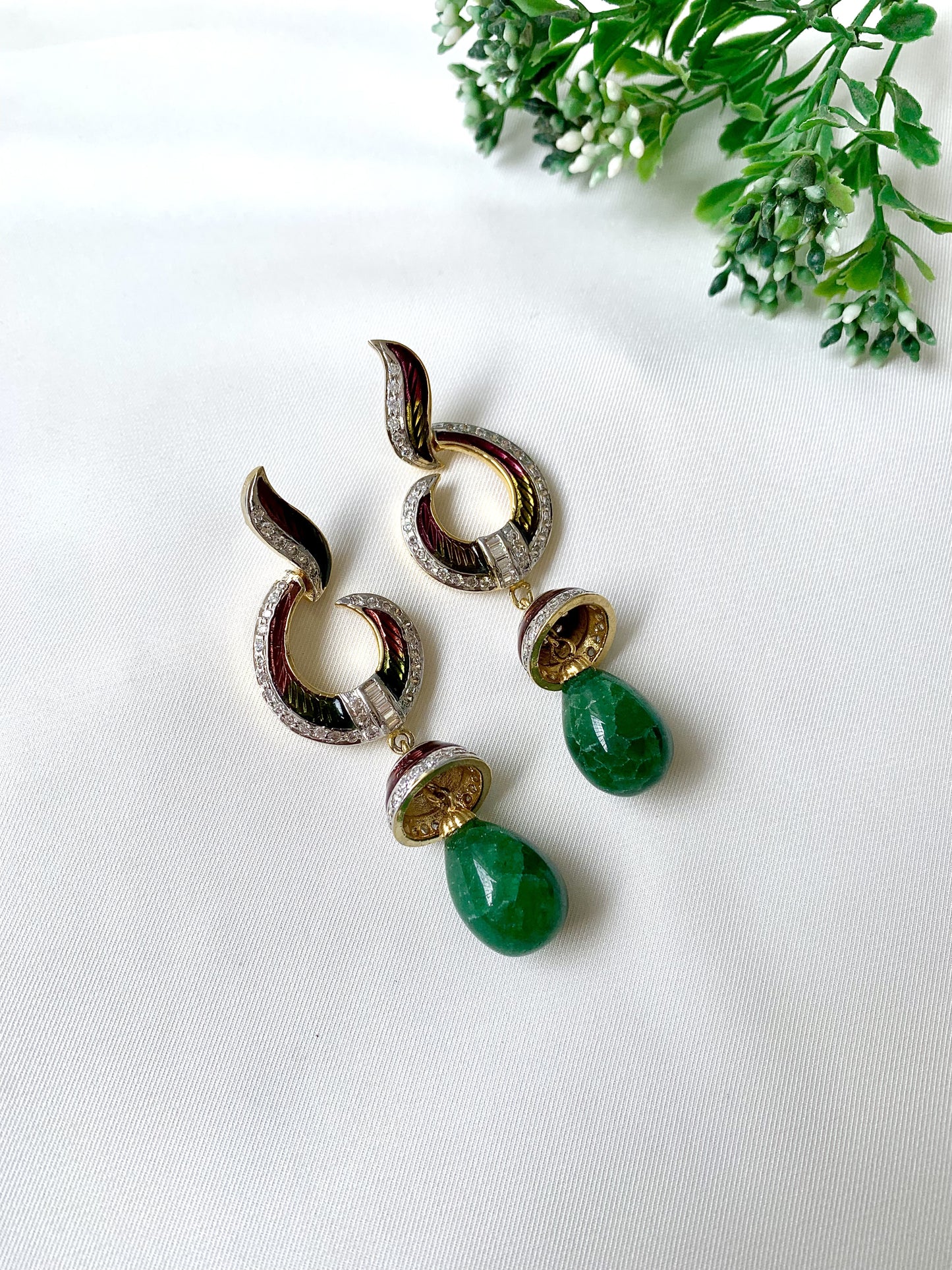 Handcrafted emerald jhumka earrings with American Diamonds and hand-painted Meena detailing in gold-tone finish