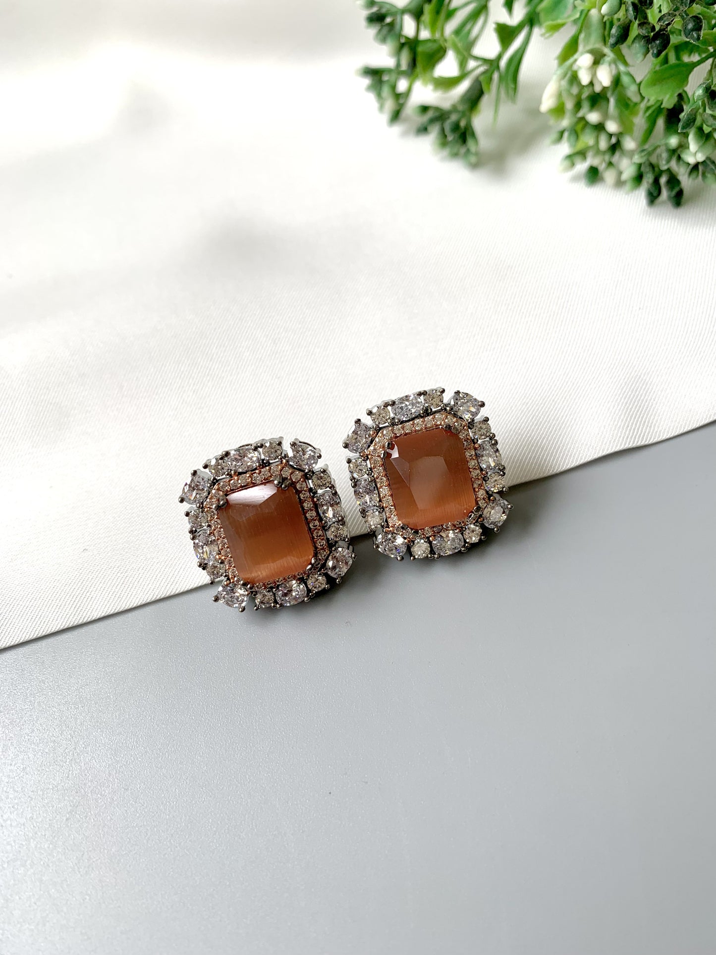 Close-up of Noir Muse Studs showcasing Onyx stone surrounded by sparkling American Diamonds