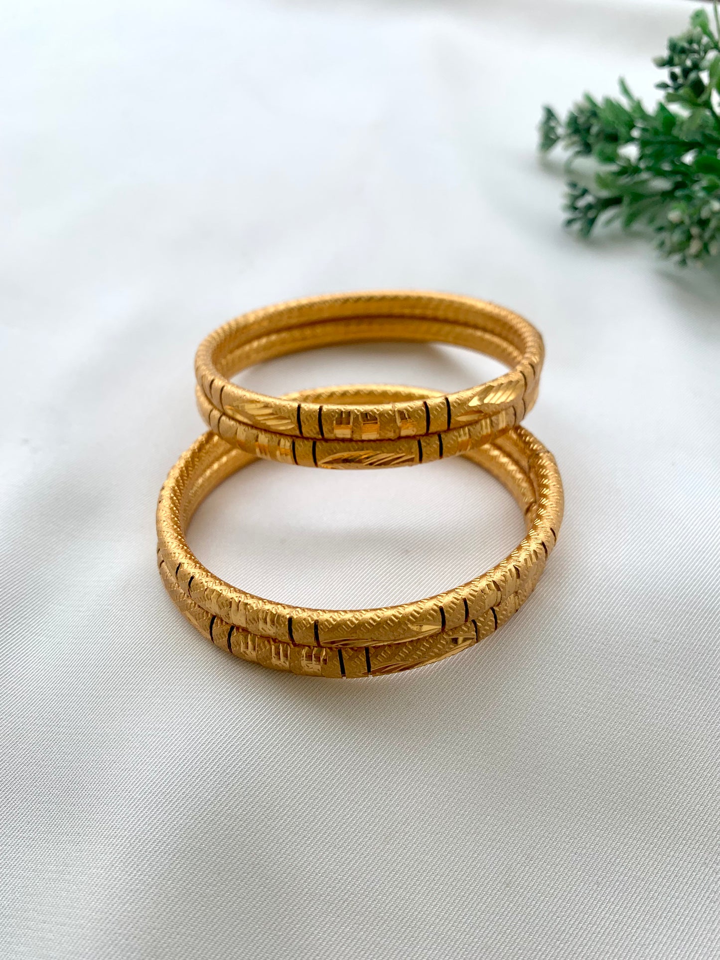 Shehla handcrafted lightweight 22kt gold plated bangles sold as a set of four and available in sizes 2.4, 2.6, and 2.8