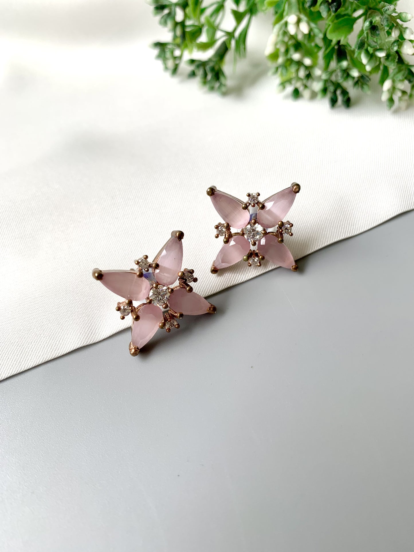 Handcrafted 22kt gold floral stud earrings with Rose Quartz and American Diamonds – front view