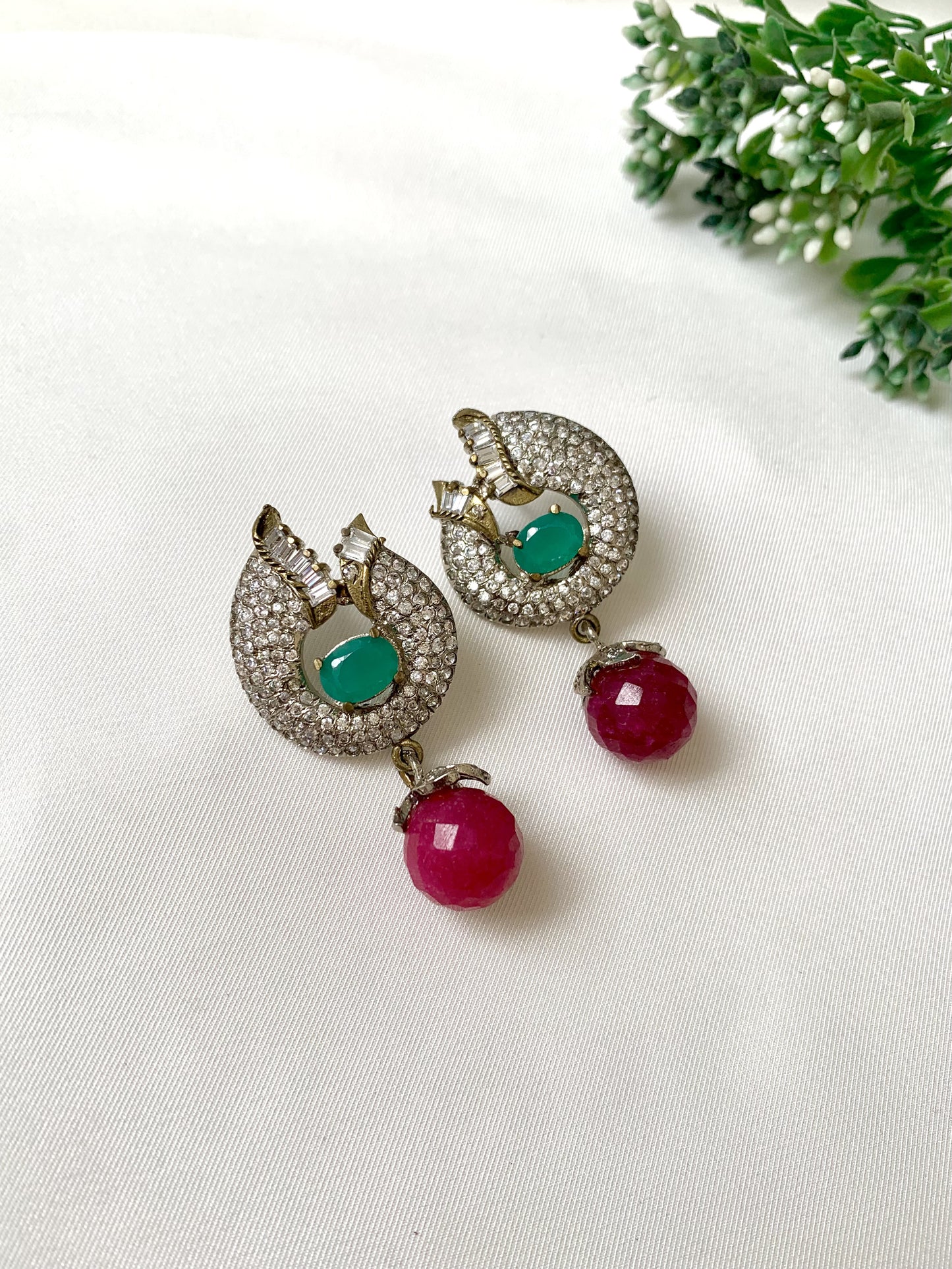 Handcrafted rhodium-plated earrings with high quality American Diamonds, semi-precious ruby and emerald stones in a Victorian finish from Zamal Jewels.