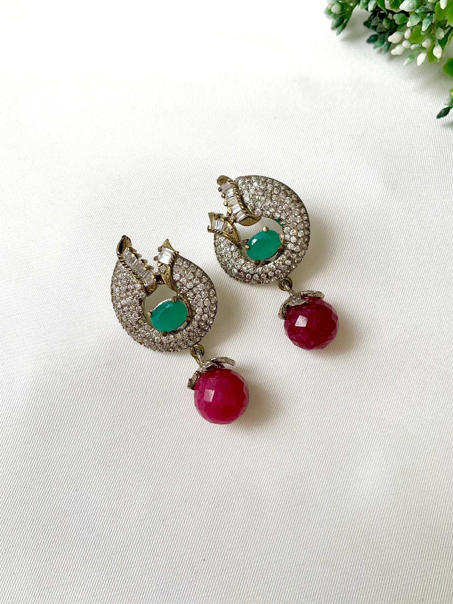 Handcrafted rhodium-plated earrings with high quality American Diamonds, semi-precious ruby and emerald stones in a Victorian finish from Zamal Jewels.