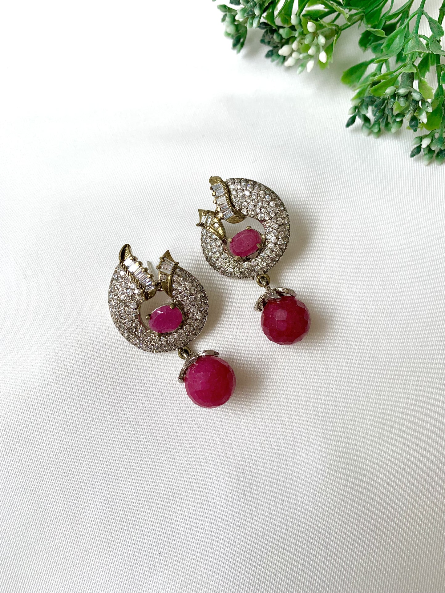 Close-up of handcrafted ruby earrings with American Diamonds in rhodium Victorian finish from Zamal Jewels