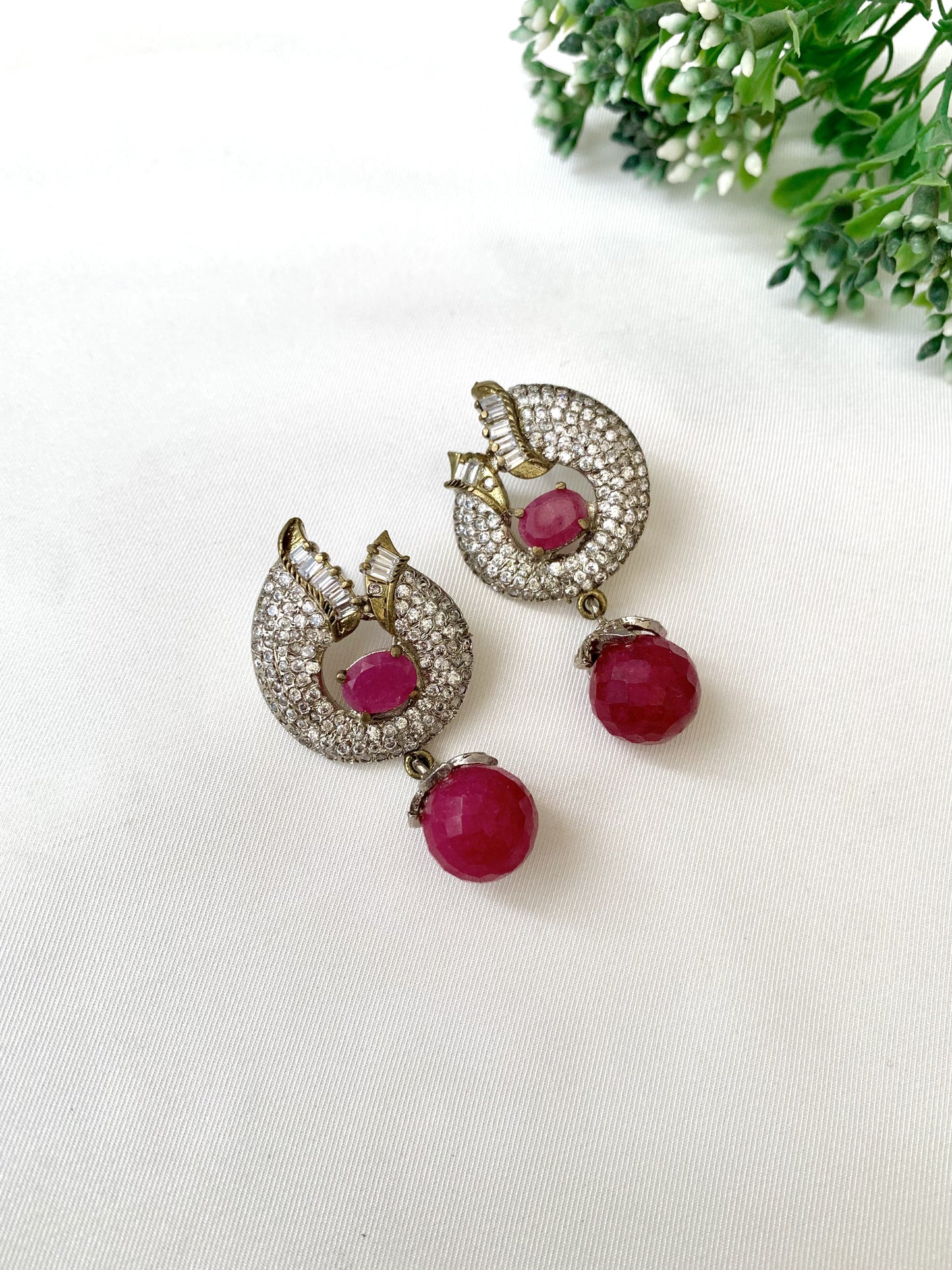 Close-up of handcrafted ruby earrings with American Diamonds in rhodium Victorian finish from Zamal Jewels