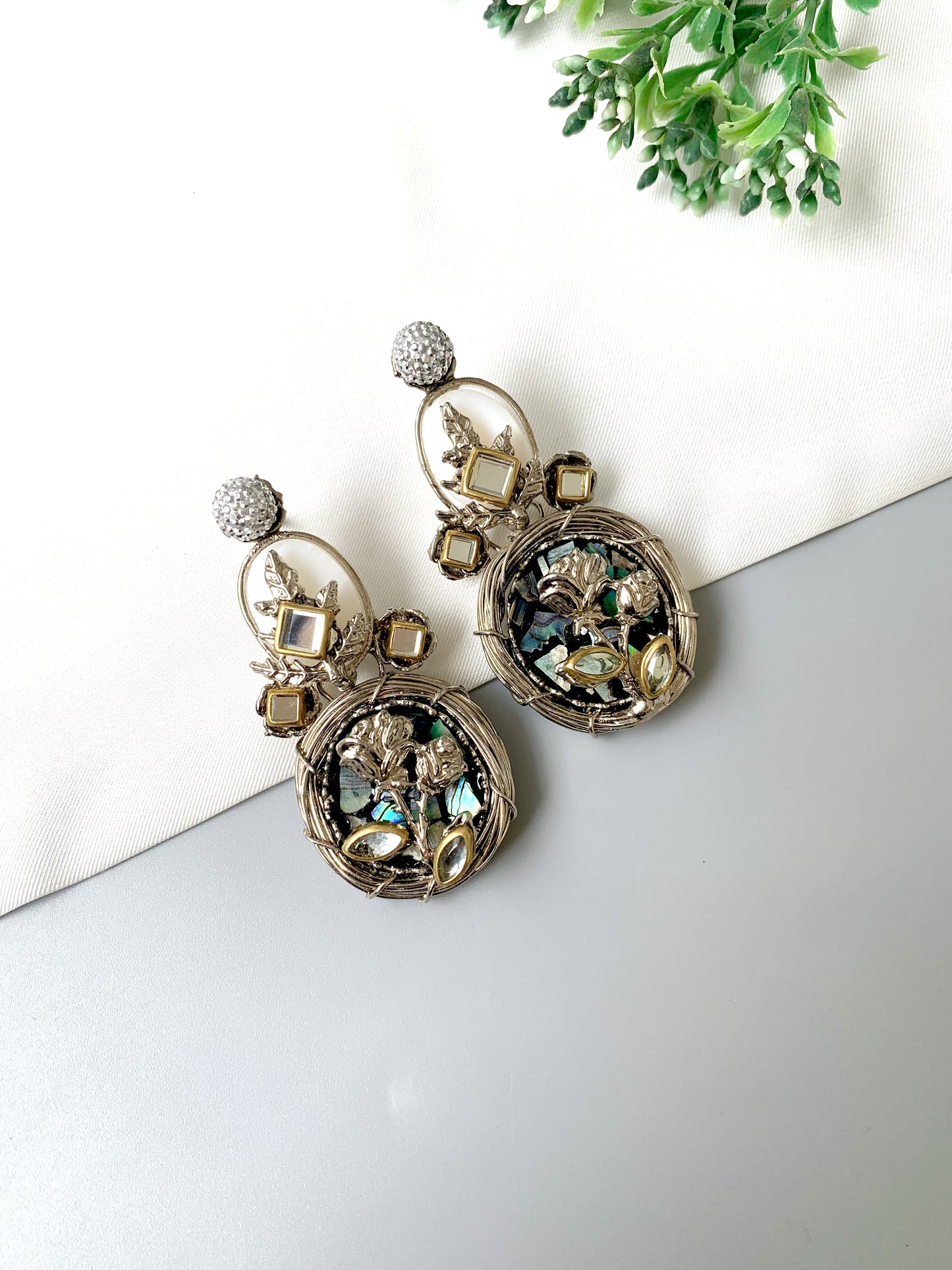 Front view of Elara Bloom silver earrings with floral detailing, American Diamonds, and moonstones in Rhodium finish.