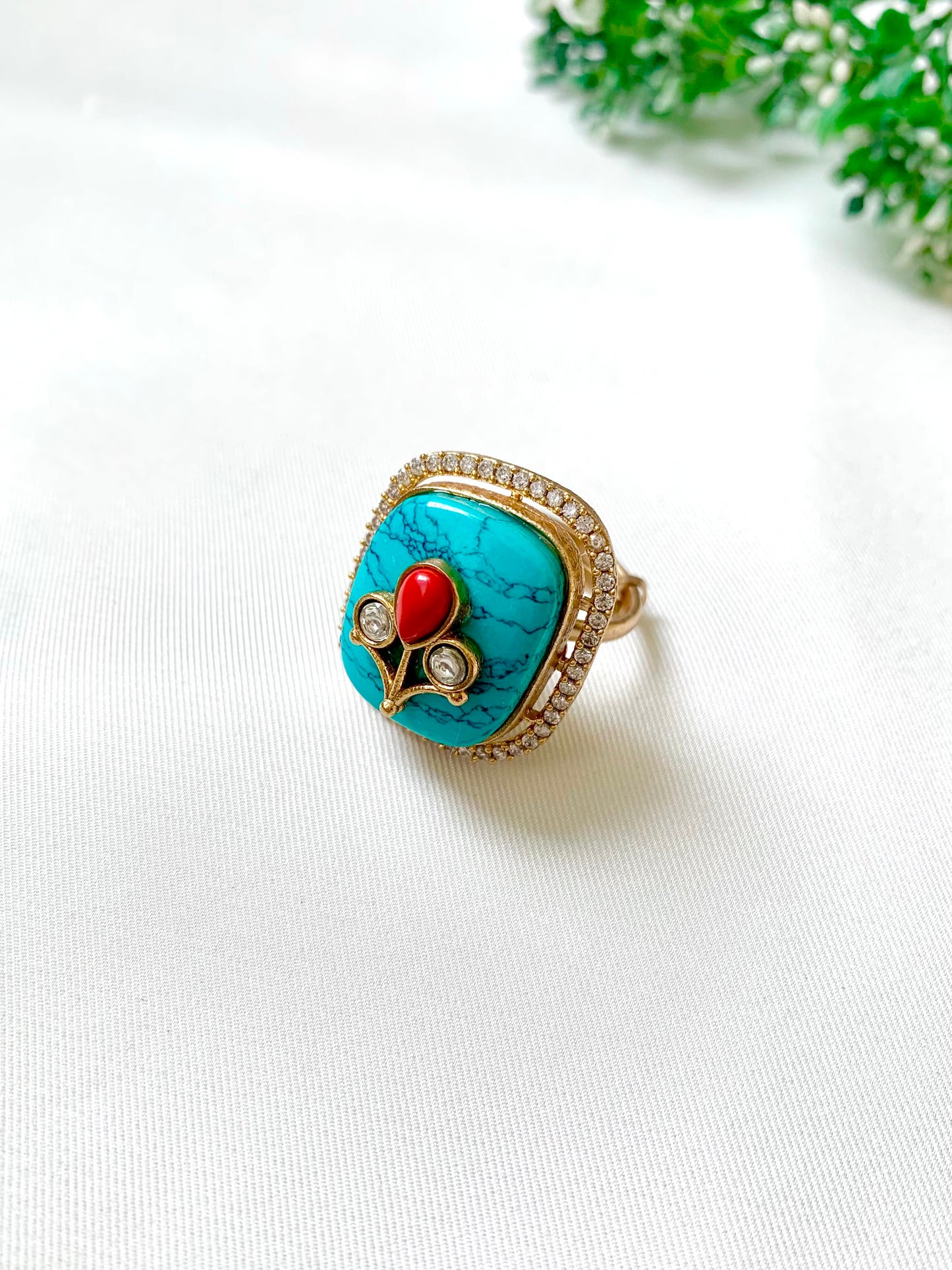 Fiza adjustable ring featuring semi-precious Feroza and Coral with American Diamonds – Angled View