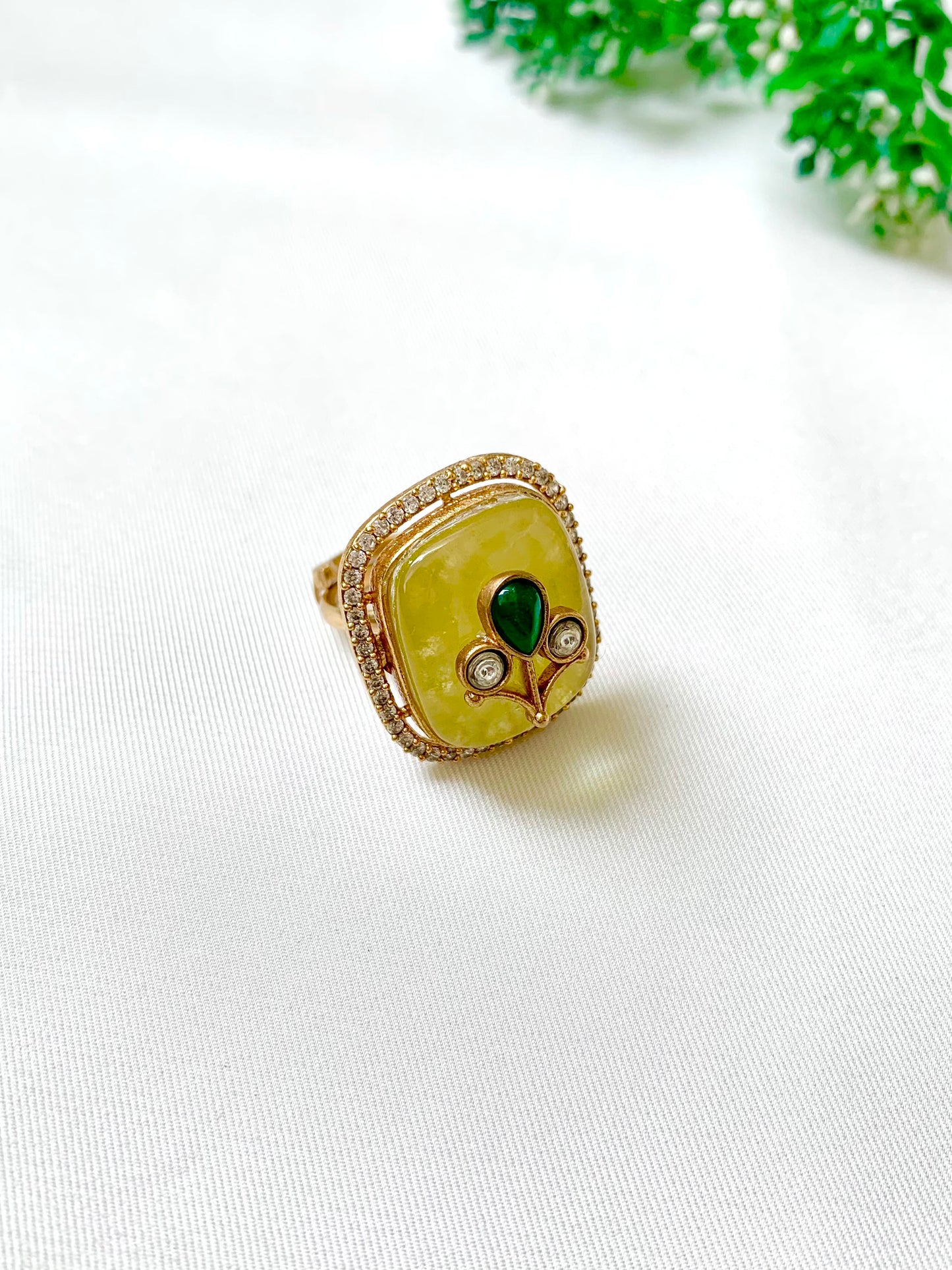 Top view of Citrine center stone accented with Emerald