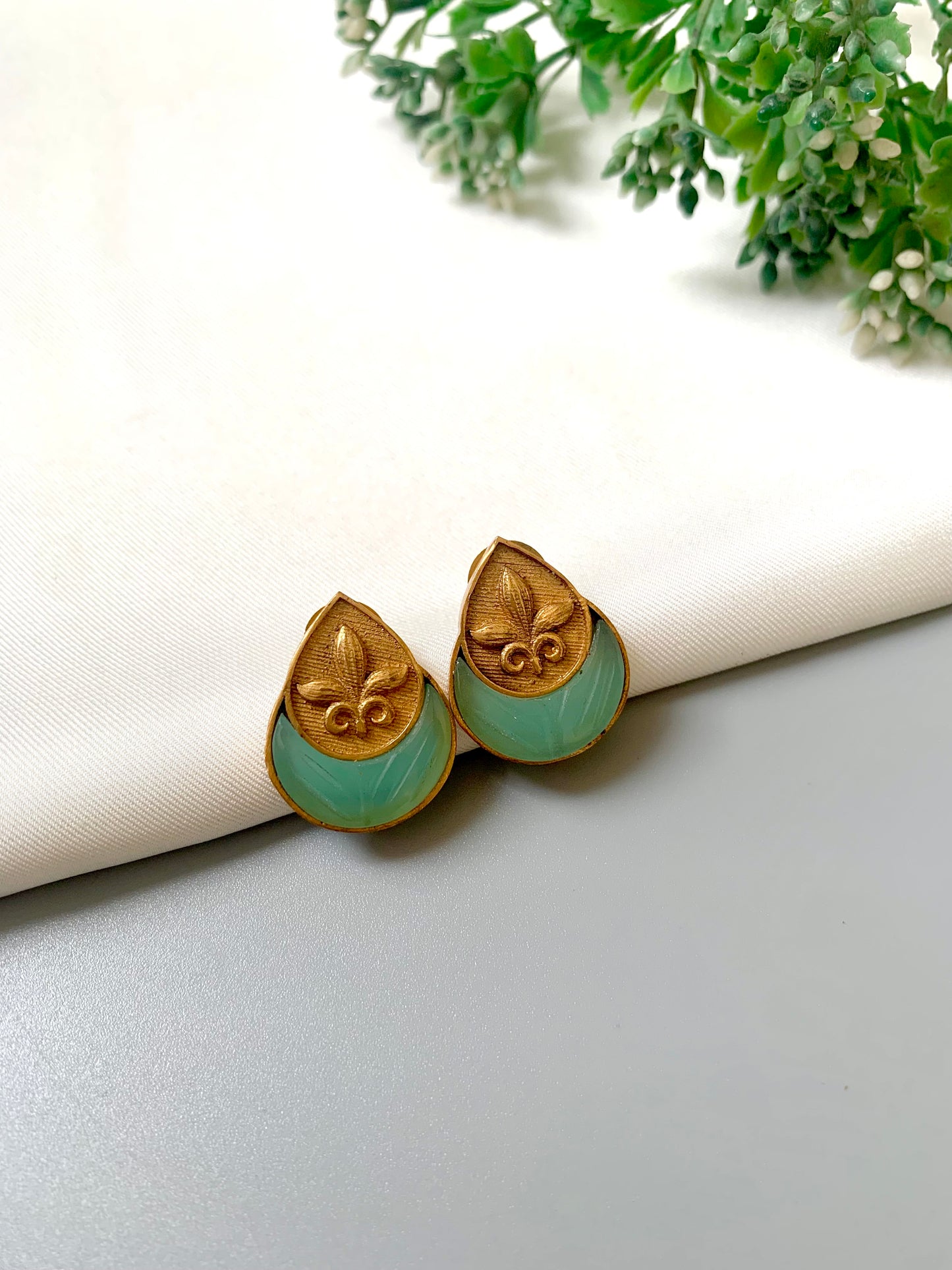 Side angle of Mint Ishani Studs showcasing intricate hand carving