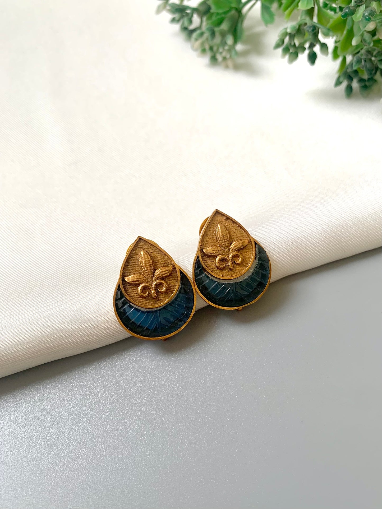 Handcrafted 22kt Victorian Gold plated Ishani studs featuring semi-precious hand-carved Sapphire stones in a matte finish.