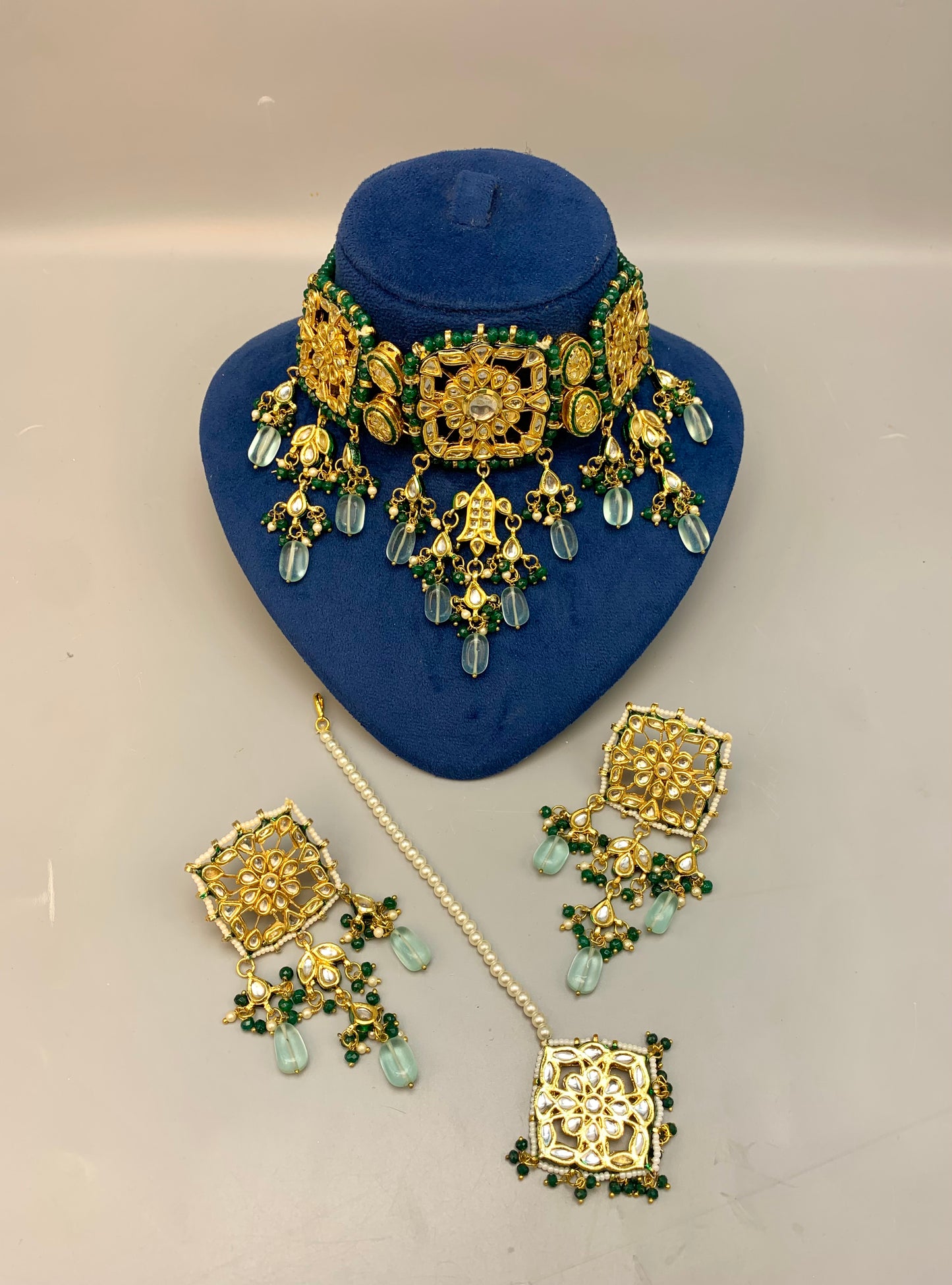Nehaal handcrafted 22kt gold plated bridal choker set with Bikaneri Kundan, hand-painted Meena, semi-precious emerald, onyx, pearls, earrings and tikka