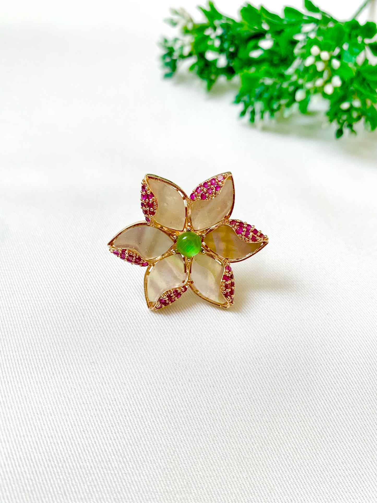Closeup of Olivia Ring showing intricate petals of Mother of Pearl and ruby detailing