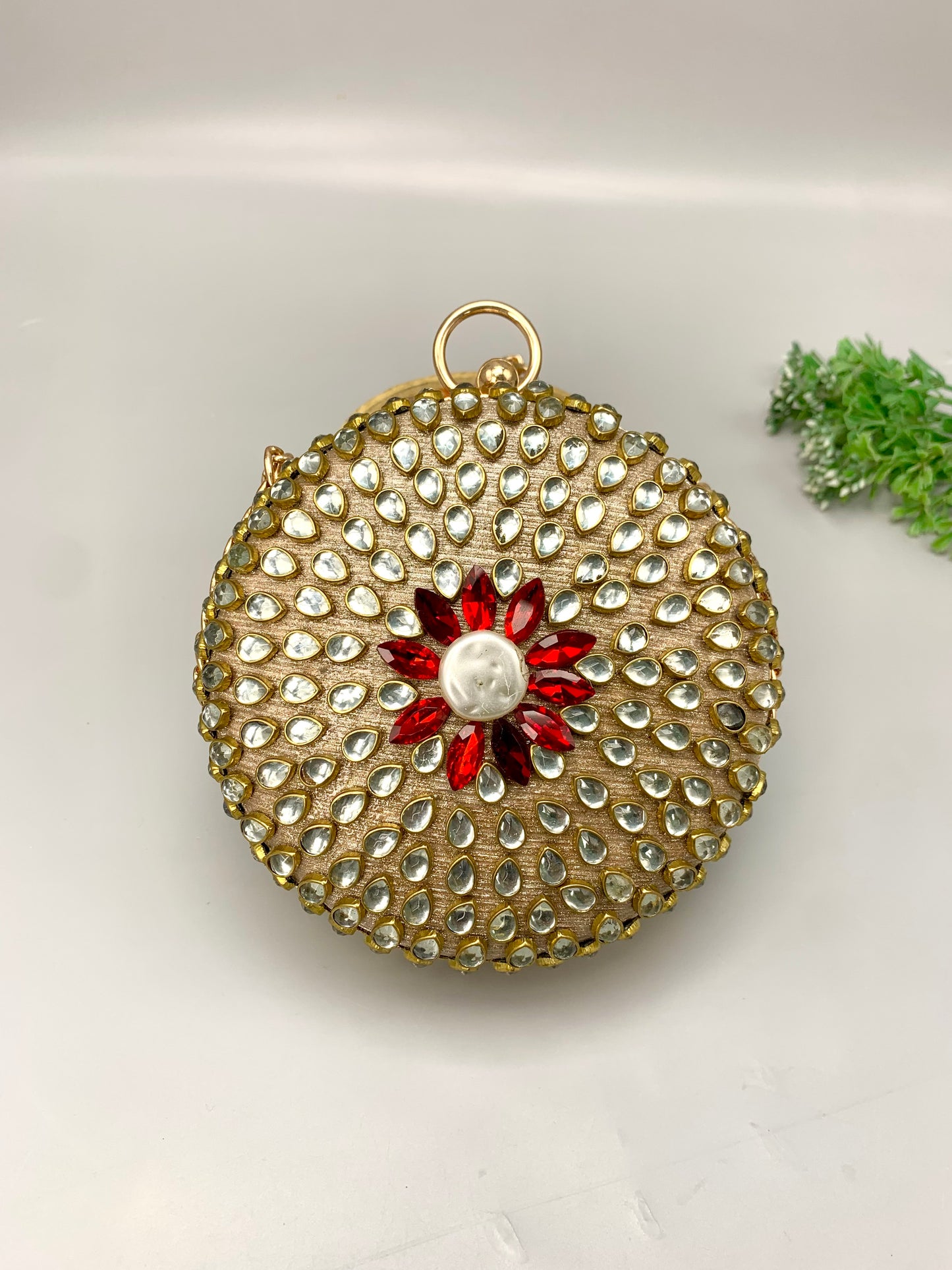 Sahar handcrafted round clutch in 22kt gold plating with kundan pearls and pearl sling detailing