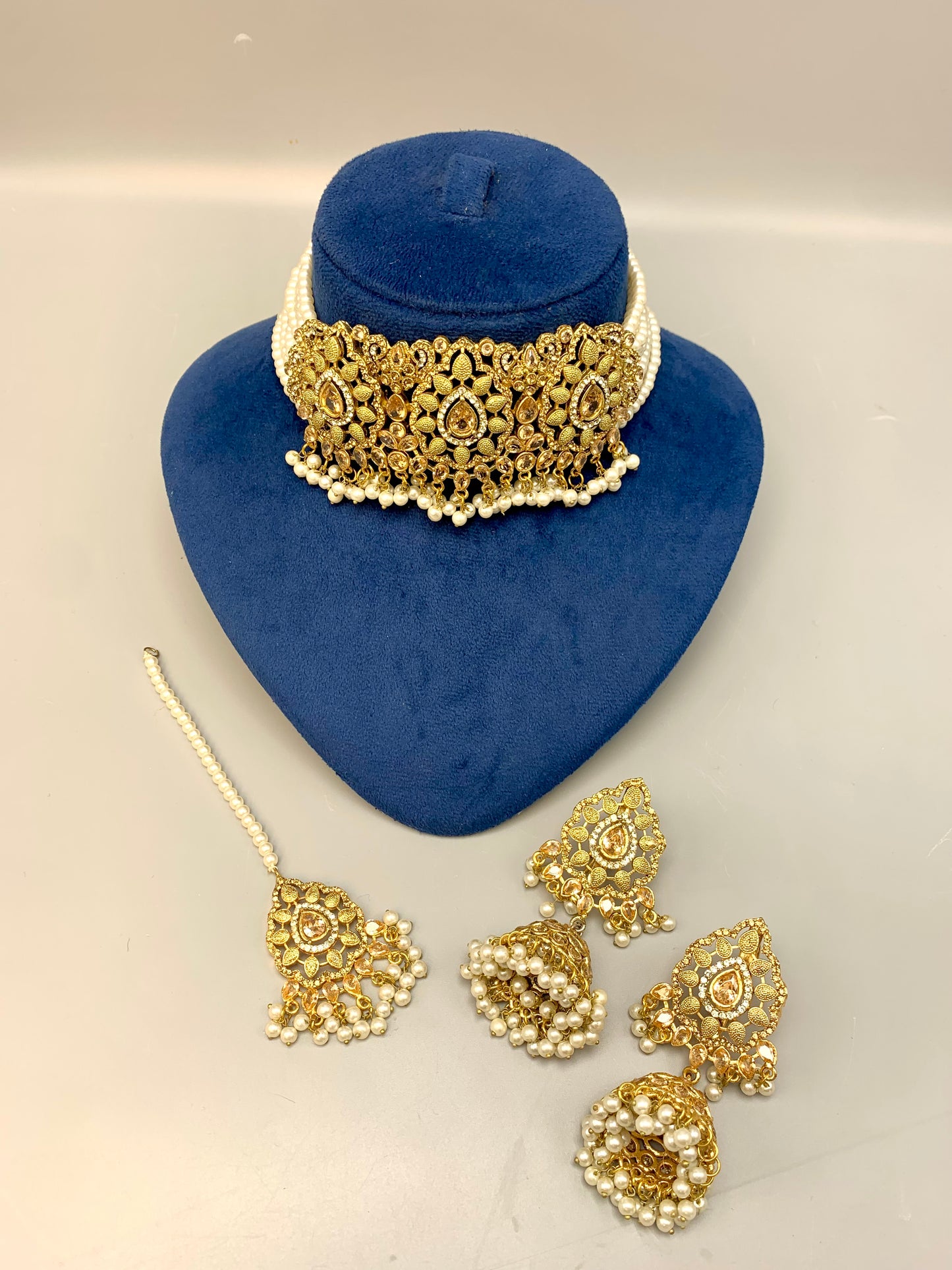 Saliha handcrafted bridal choker set in 22kt gold plating with American diamonds, semi-precious Polki, champagne stones, pearls and matching tikka