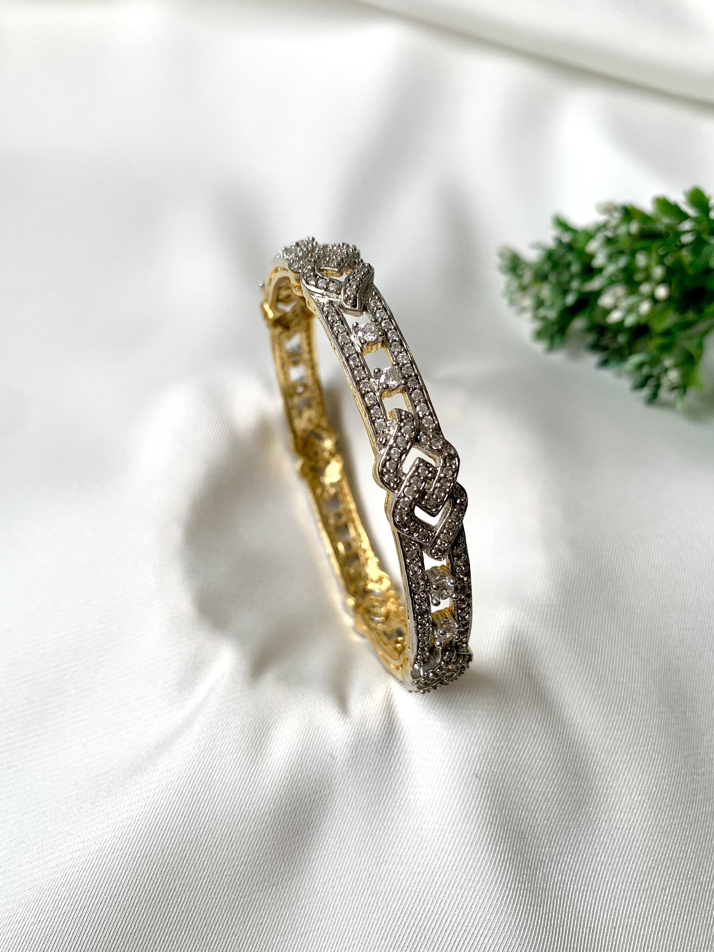 Zahra diamond link bangle in vertical position with gold and diamond finish
