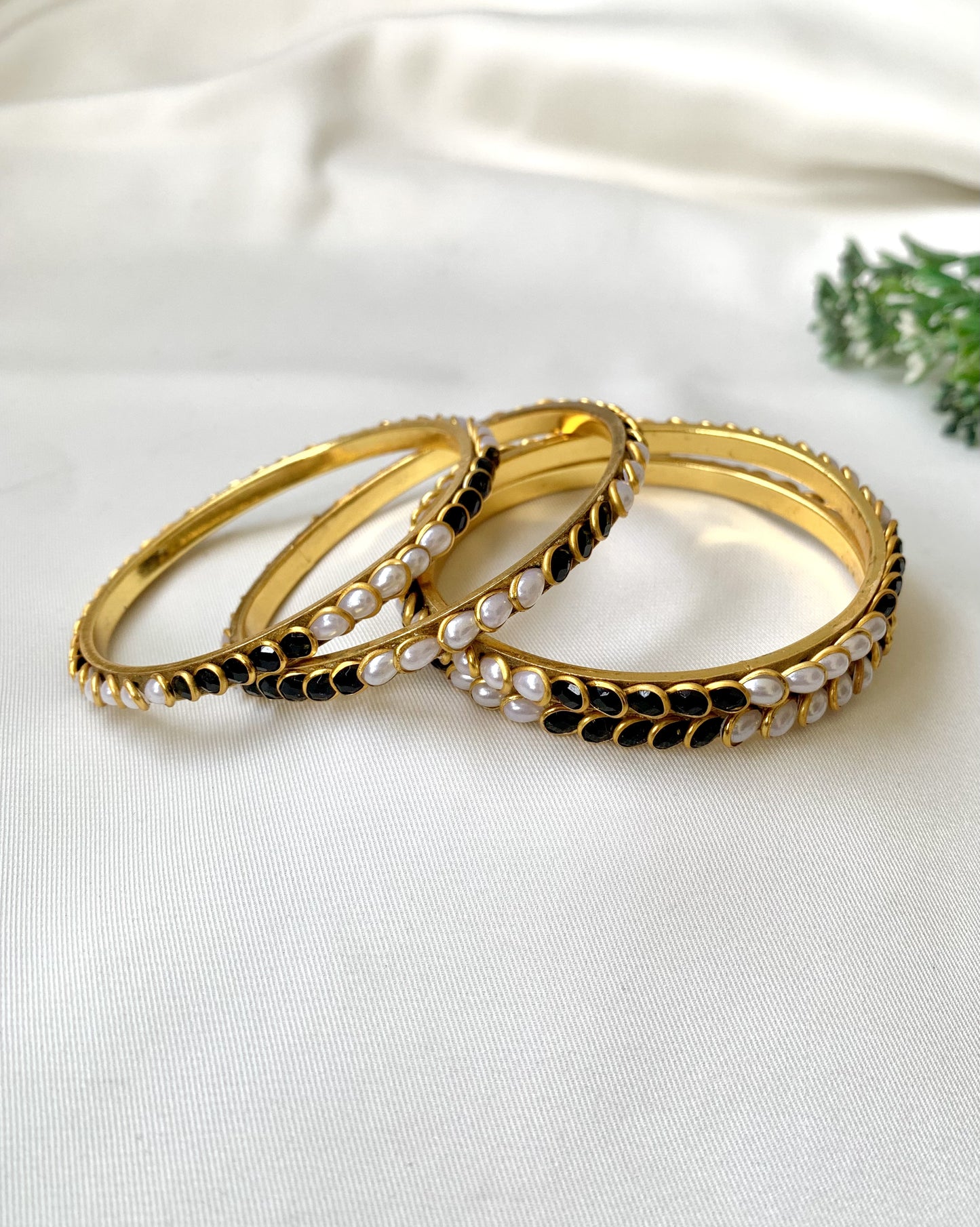 Handcrafted Inaya Bangles in 22kt gold plating with Onyx and Pearls — set of 4 bangles by Zamal Jewels.