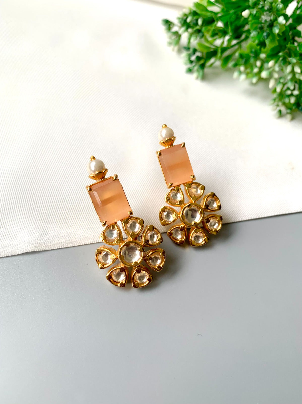 Handcrafted earrings with Polki Kundan, Orange Onyx, and semi-precious pearls in 22kt gold plating by Zamal Jewels