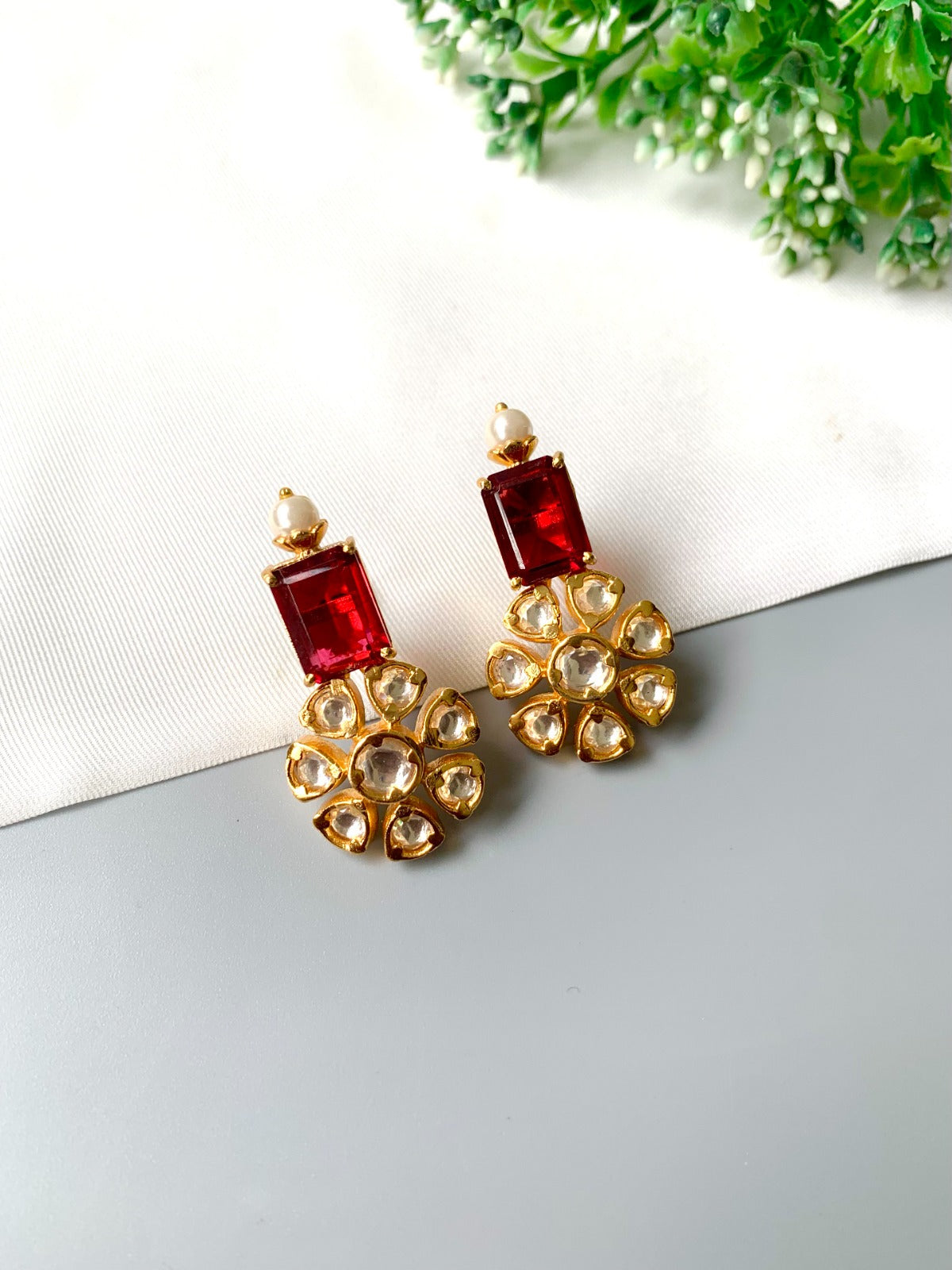 Handcrafted ruby earrings with Polki Kundan and semi-precious pearls in 22kt gold plating by Zamal Jewels.
