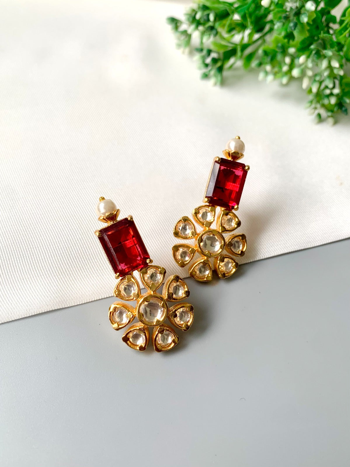 Handcrafted ruby earrings with Polki Kundan and semi-precious pearls in 22kt gold plating by Zamal Jewels.