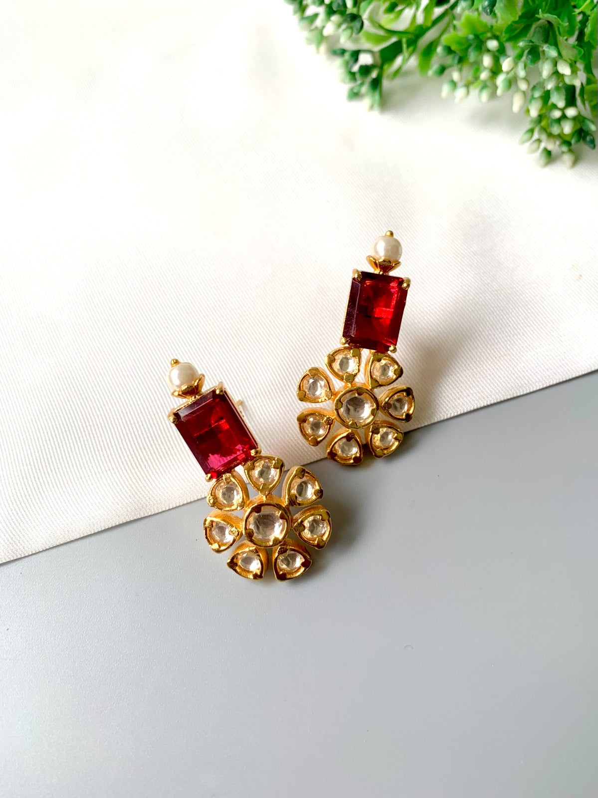 Handcrafted ruby earrings with Polki Kundan and semi-precious pearls in 22kt gold plating by Zamal Jewels.