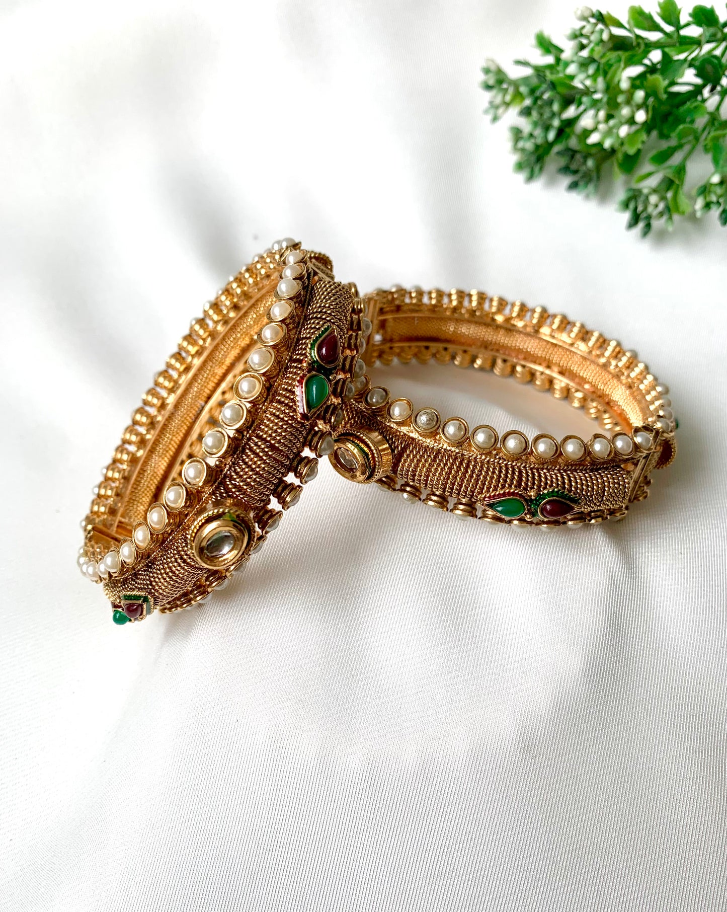 Pair of handcrafted 22kt gold plated openable screw bangles with Kundan, semi-precious pearls, ruby, and emerald stones