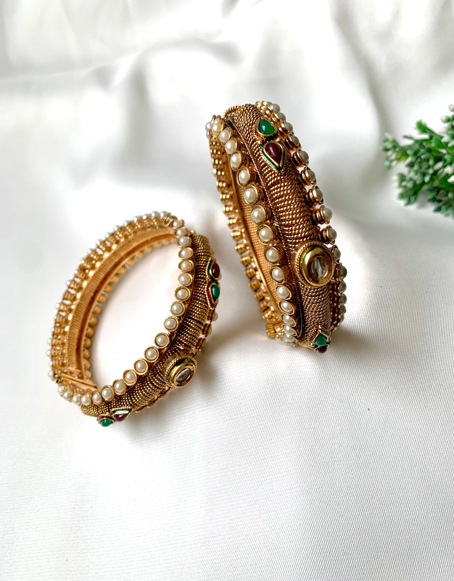 Pair of handcrafted 22kt gold plated openable screw bangles with Kundan, semi-precious pearls, ruby, and emerald stones