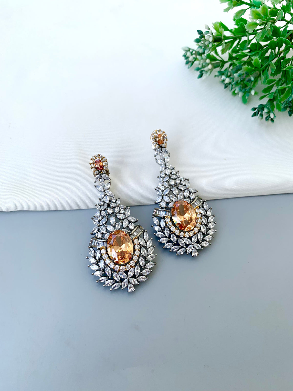 Ameera handcrafted oxidized Rhodium earrings with Victorian diamond finish, American Diamonds and Champagne stones