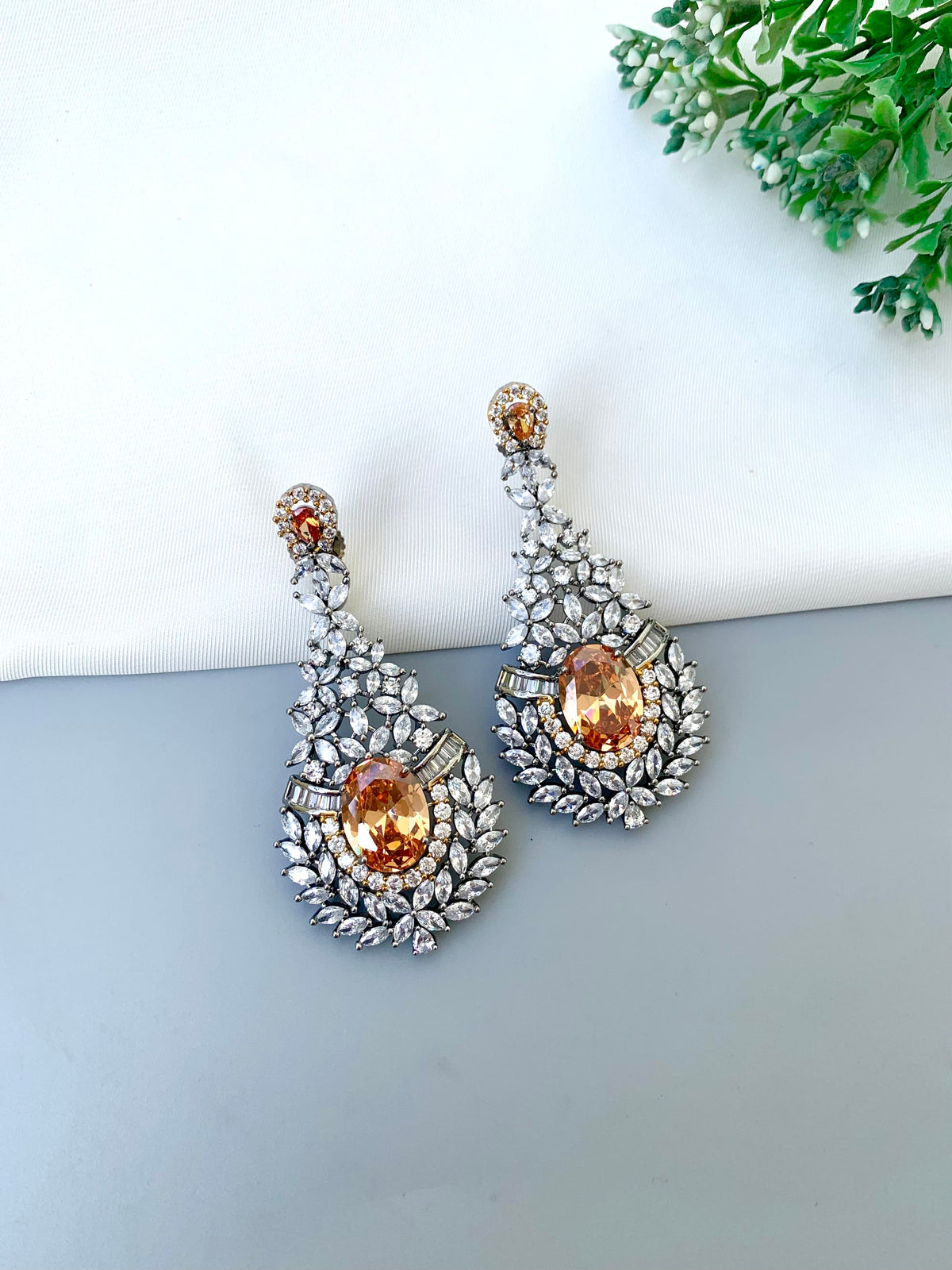 Ameera handcrafted oxidized Rhodium earrings with Victorian diamond finish, American Diamonds and Champagne stones