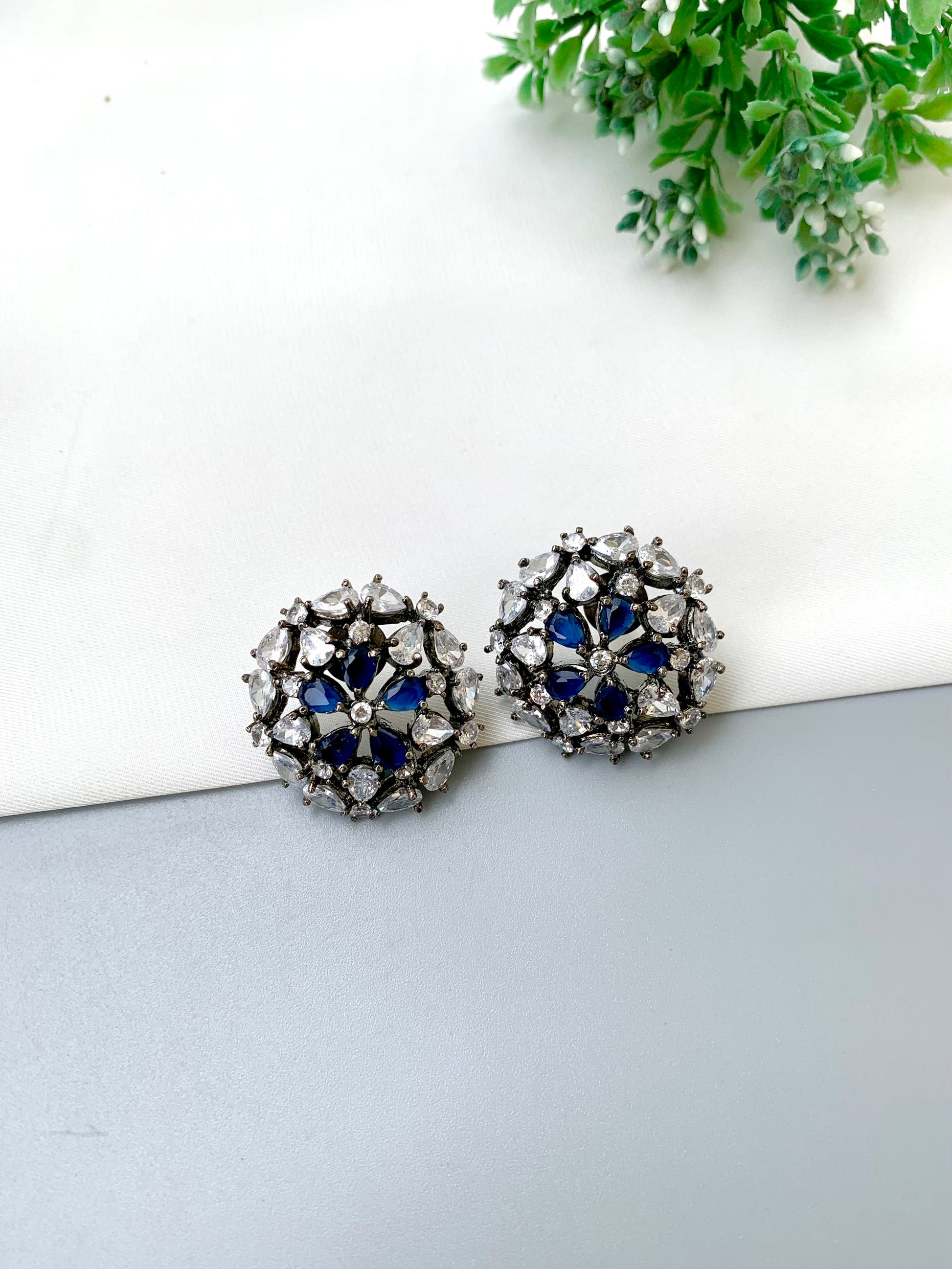 Avena handcrafted oxidized Rhodium plated stud earrings featuring American Diamonds and semi-precious Sapphire