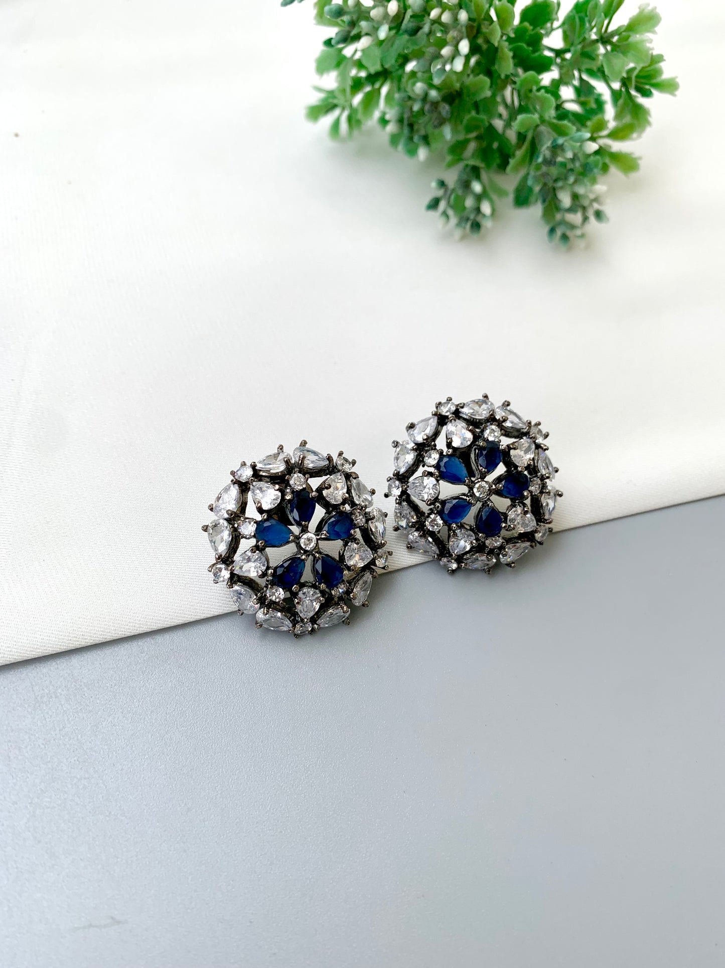 Avena handcrafted oxidized Rhodium plated stud earrings featuring American Diamonds and semi-precious Sapphire