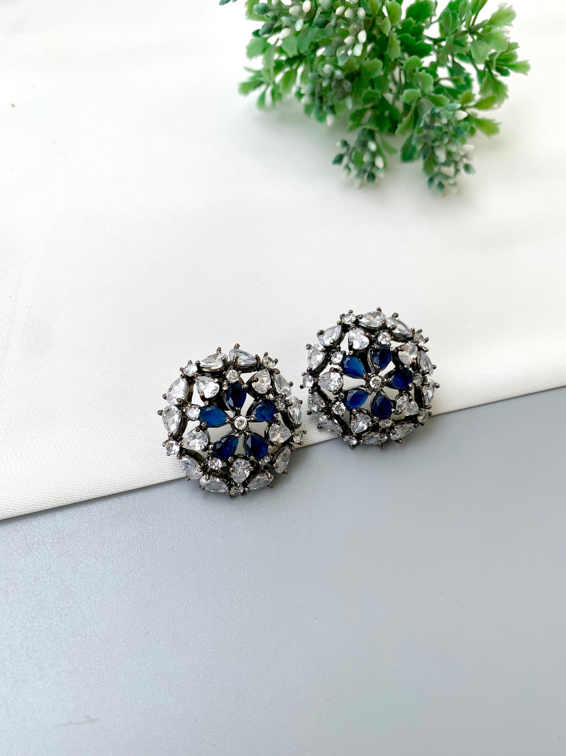 Avena handcrafted oxidized Rhodium plated stud earrings featuring American Diamonds and semi-precious Sapphire