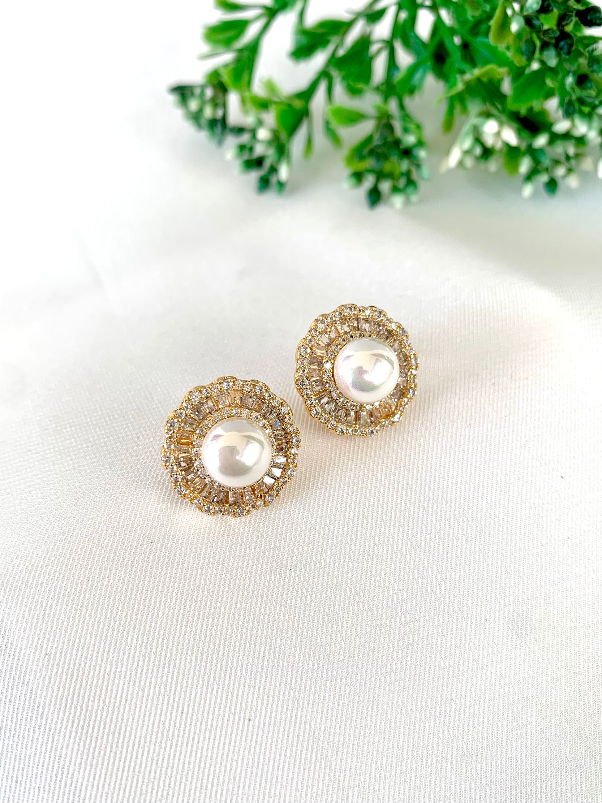 Round stud earrings with pearl center and American Diamond halo