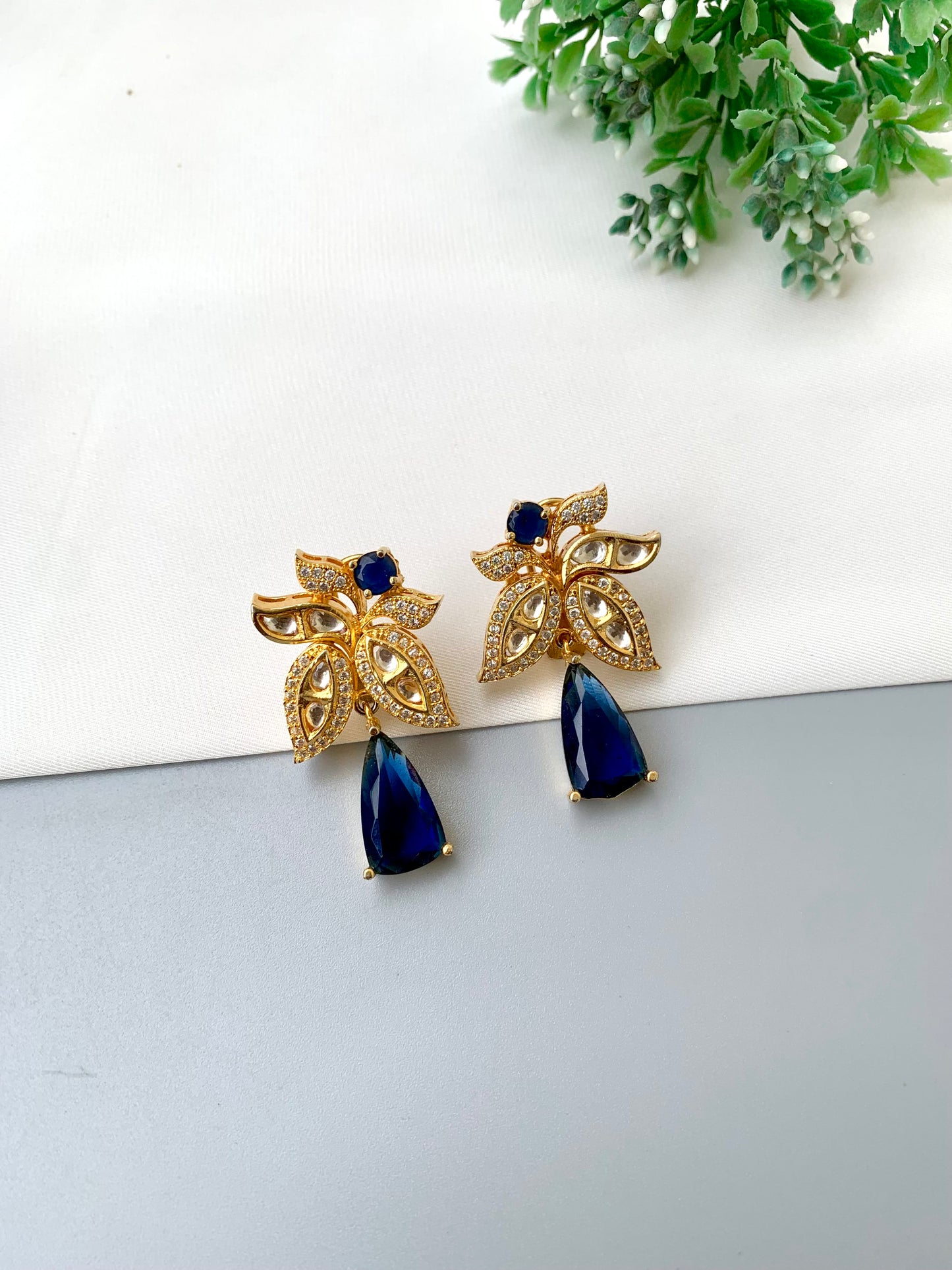 Beenam handcrafted 22kt Gold plated earrings featuring Polki Kundan, American Diamonds and semi-precious Sapphire