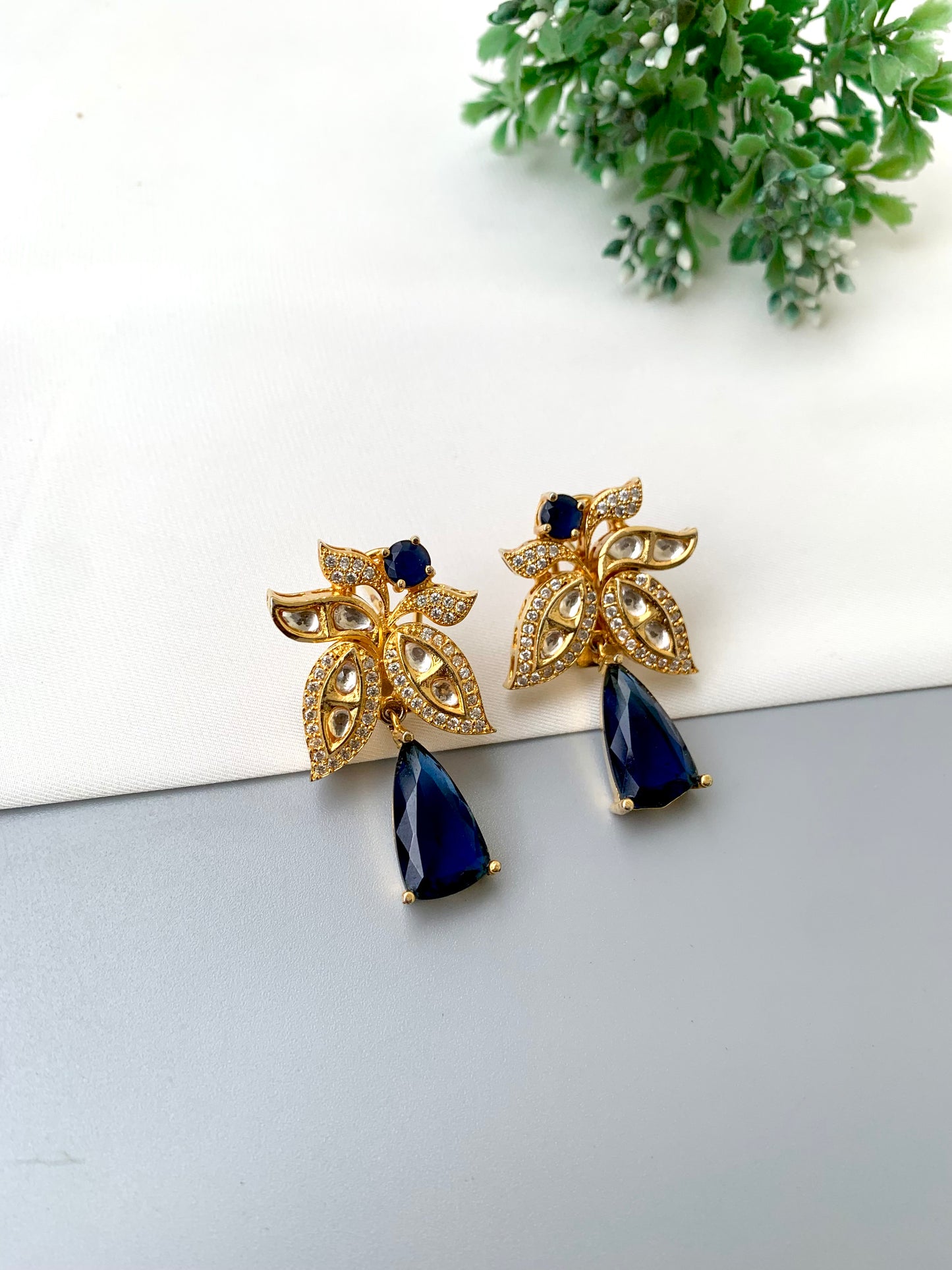 Beenam handcrafted 22kt Gold plated earrings featuring Polki Kundan, American Diamonds and semi-precious Sapphire