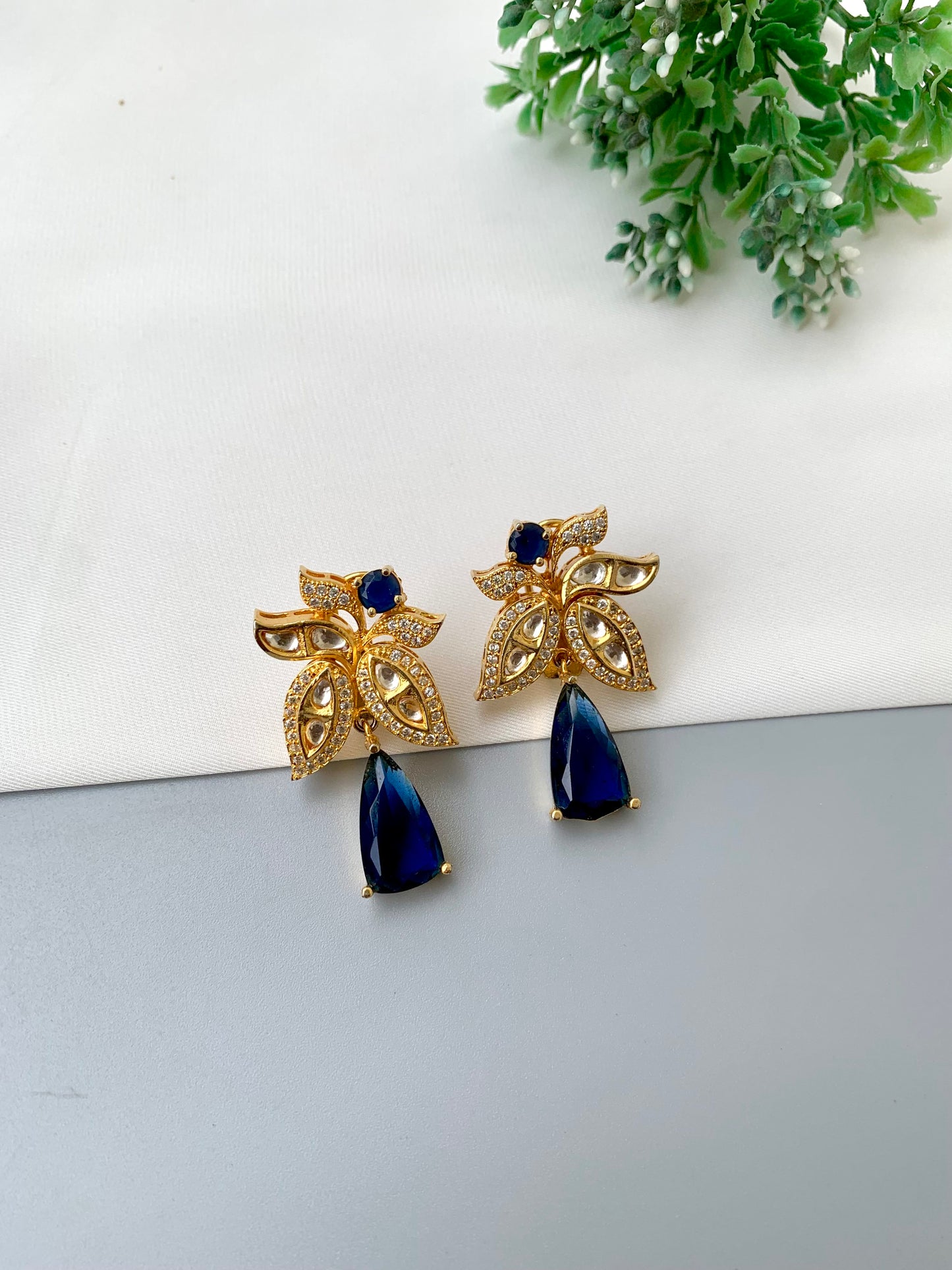 Beenam handcrafted 22kt Gold plated earrings featuring Polki Kundan, American Diamonds and semi-precious Sapphire