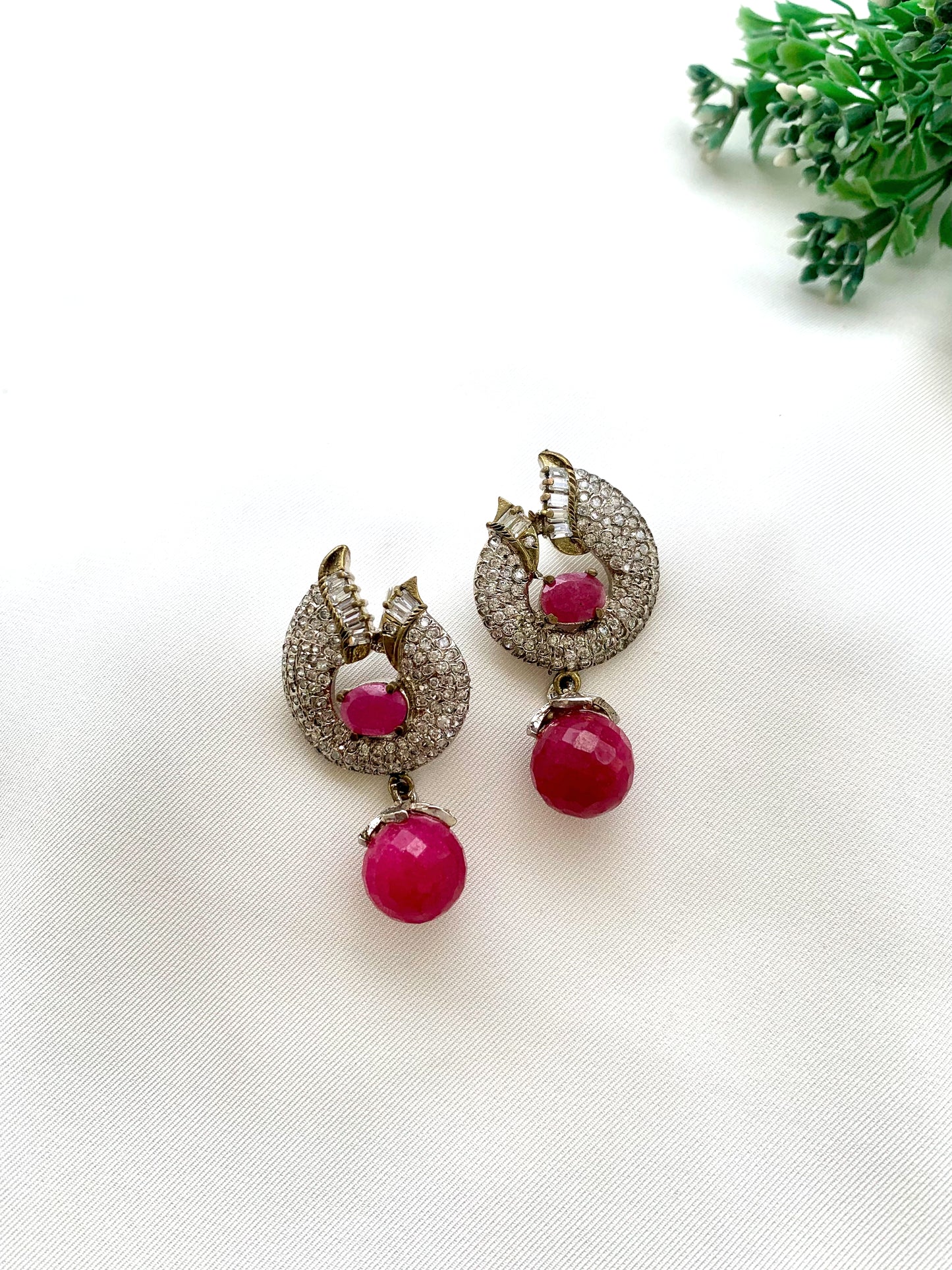 Bianca handcrafted rhodium plated earrings with a diamond finish featuring American Diamonds and semi-precious Ruby
