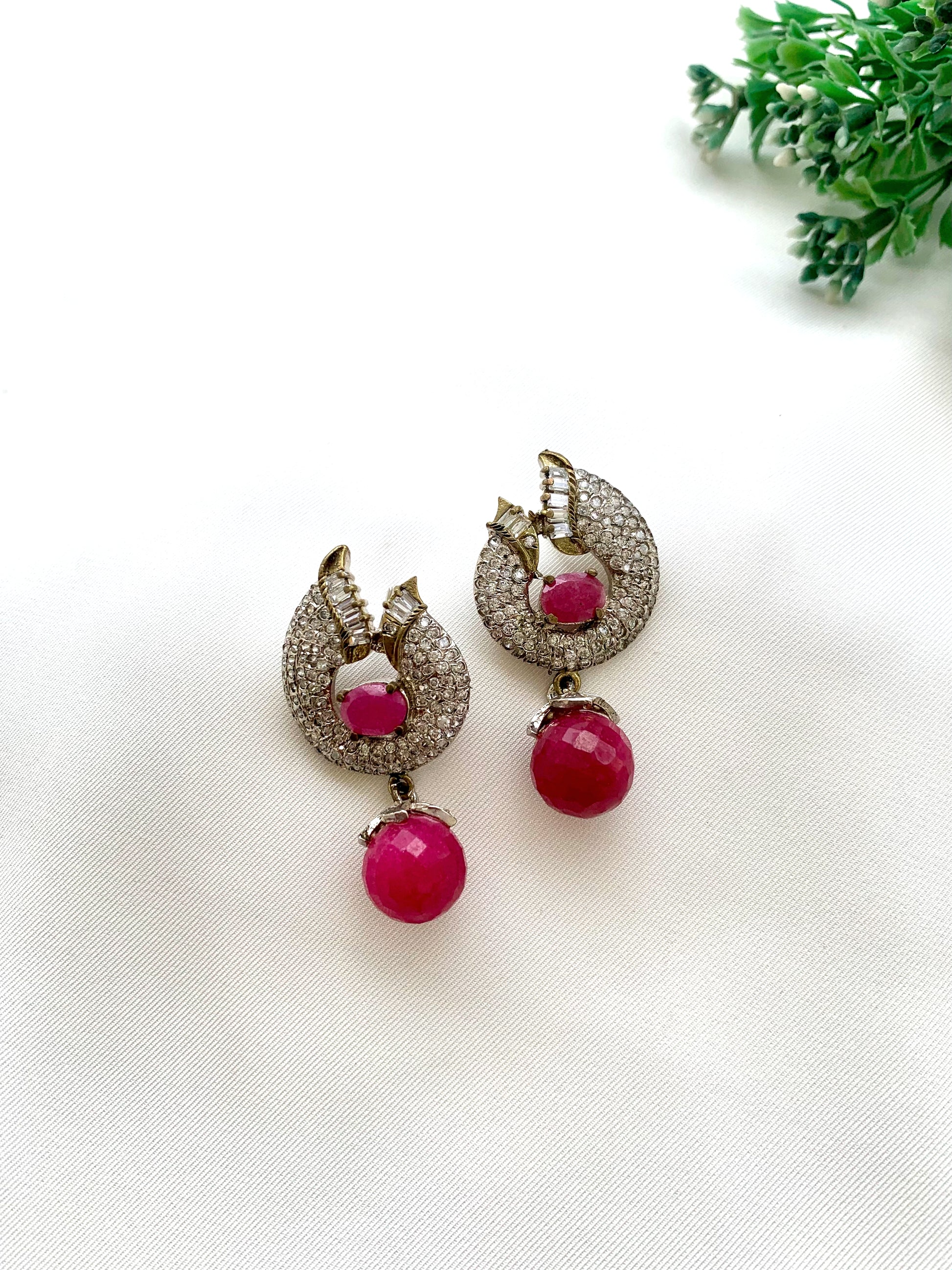 Bianca handcrafted rhodium plated earrings with a diamond finish featuring American Diamonds and semi-precious Ruby