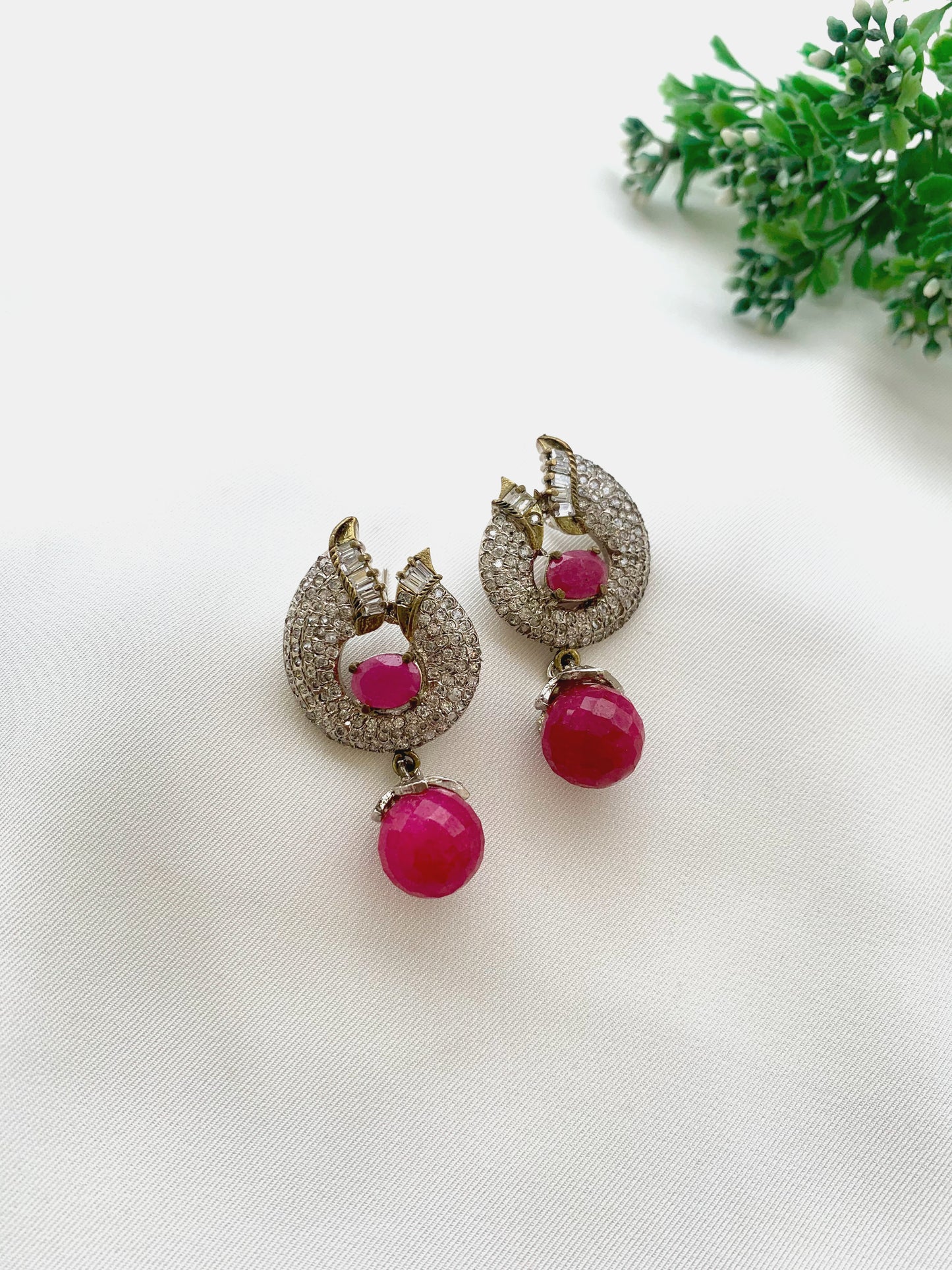 Bianca handcrafted rhodium plated earrings with a diamond finish featuring American Diamonds and semi-precious Ruby