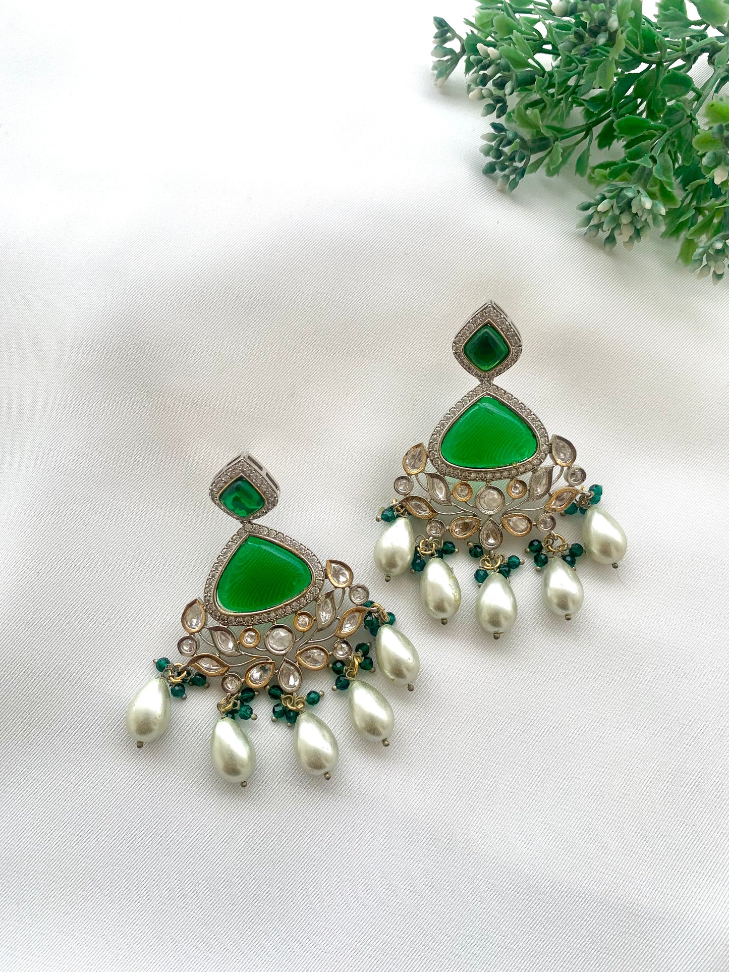 Bisne handcrafted rhodium plated earrings featuring American Diamonds, authentic Kundan, semi-precious Onyx, Emerald, and Pearls