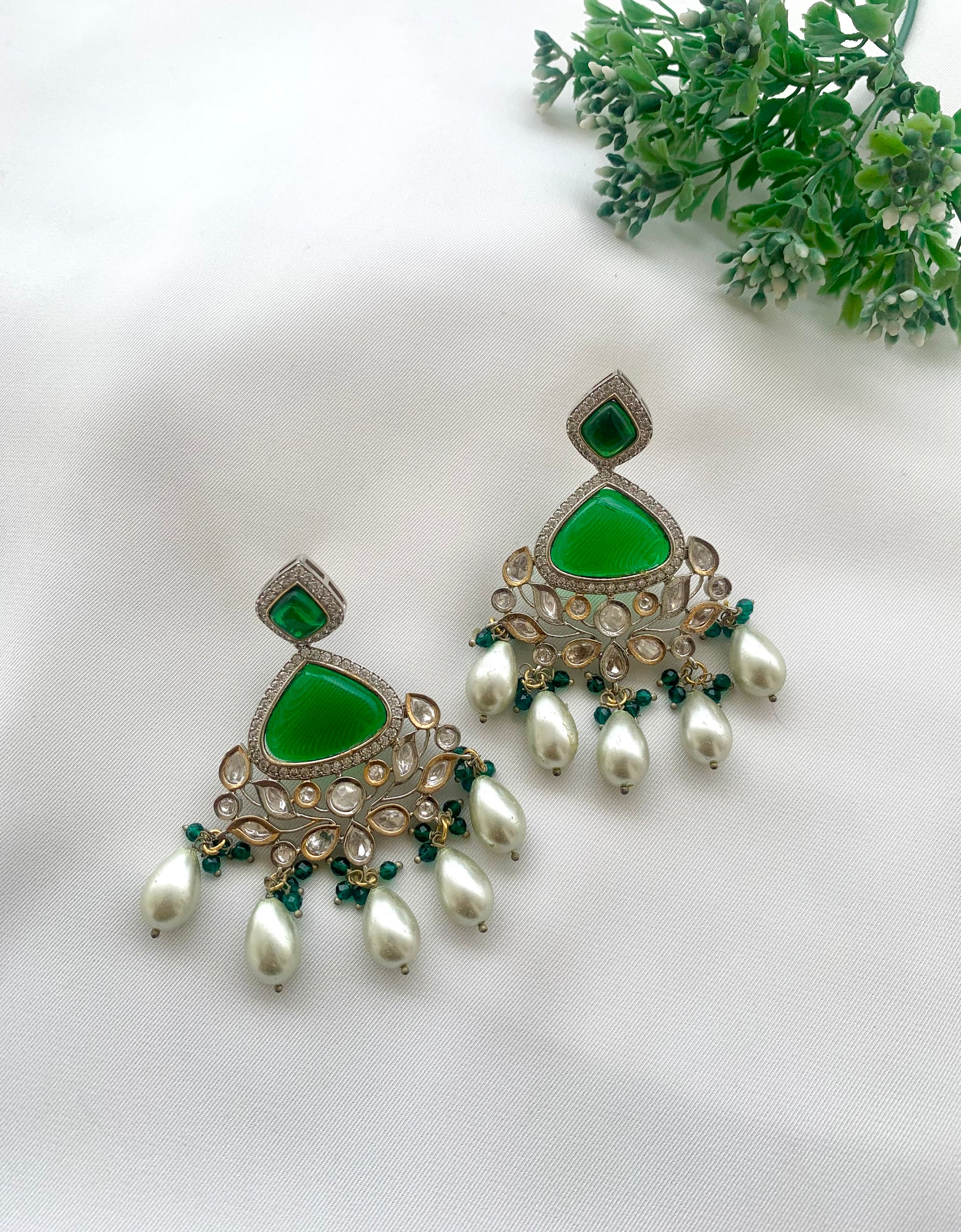 Bisne handcrafted rhodium plated earrings featuring American Diamonds, authentic Kundan, semi-precious Onyx, Emerald, and Pearls