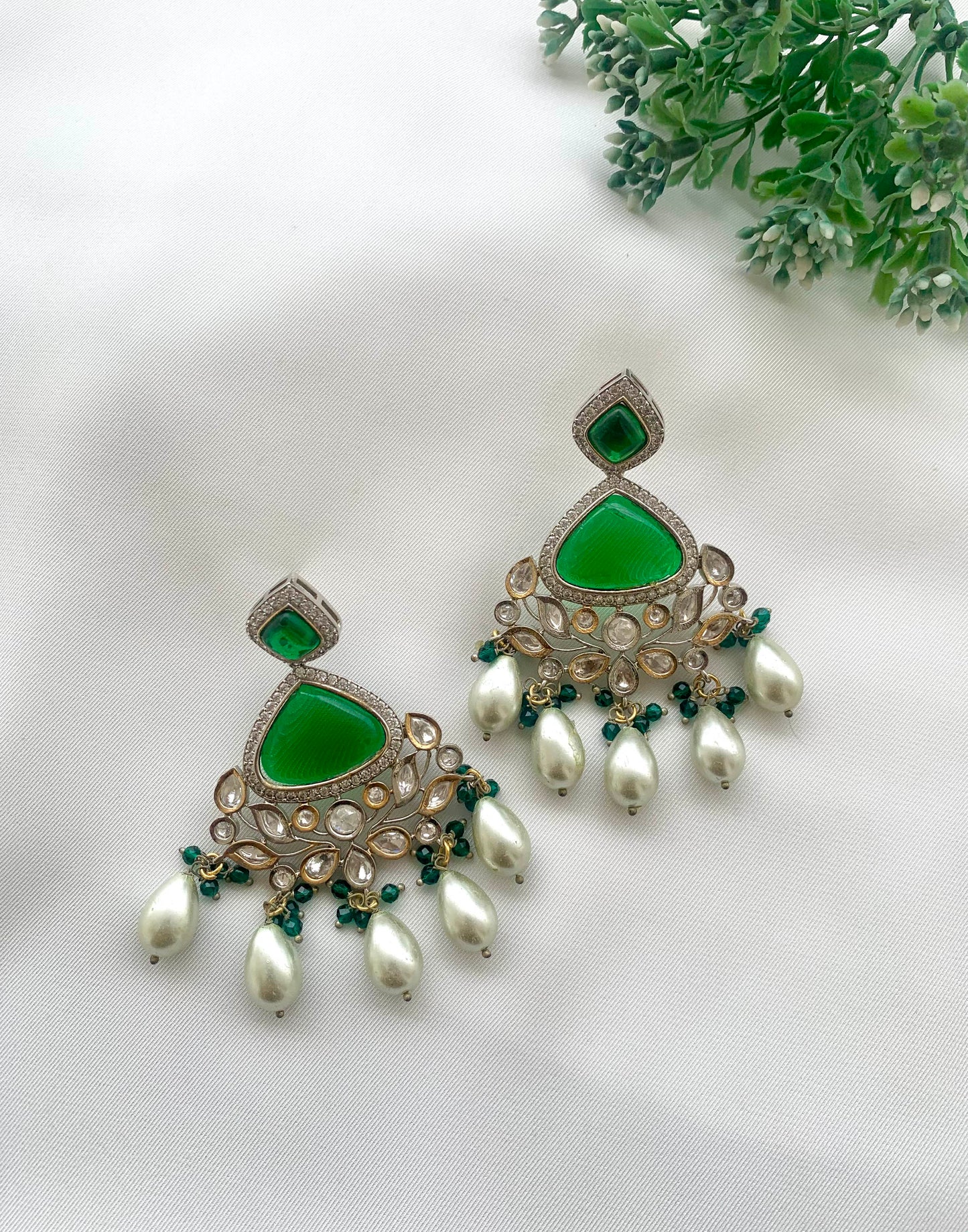 Bisne handcrafted rhodium plated earrings featuring American Diamonds, authentic Kundan, semi-precious Onyx, Emerald, and Pearls