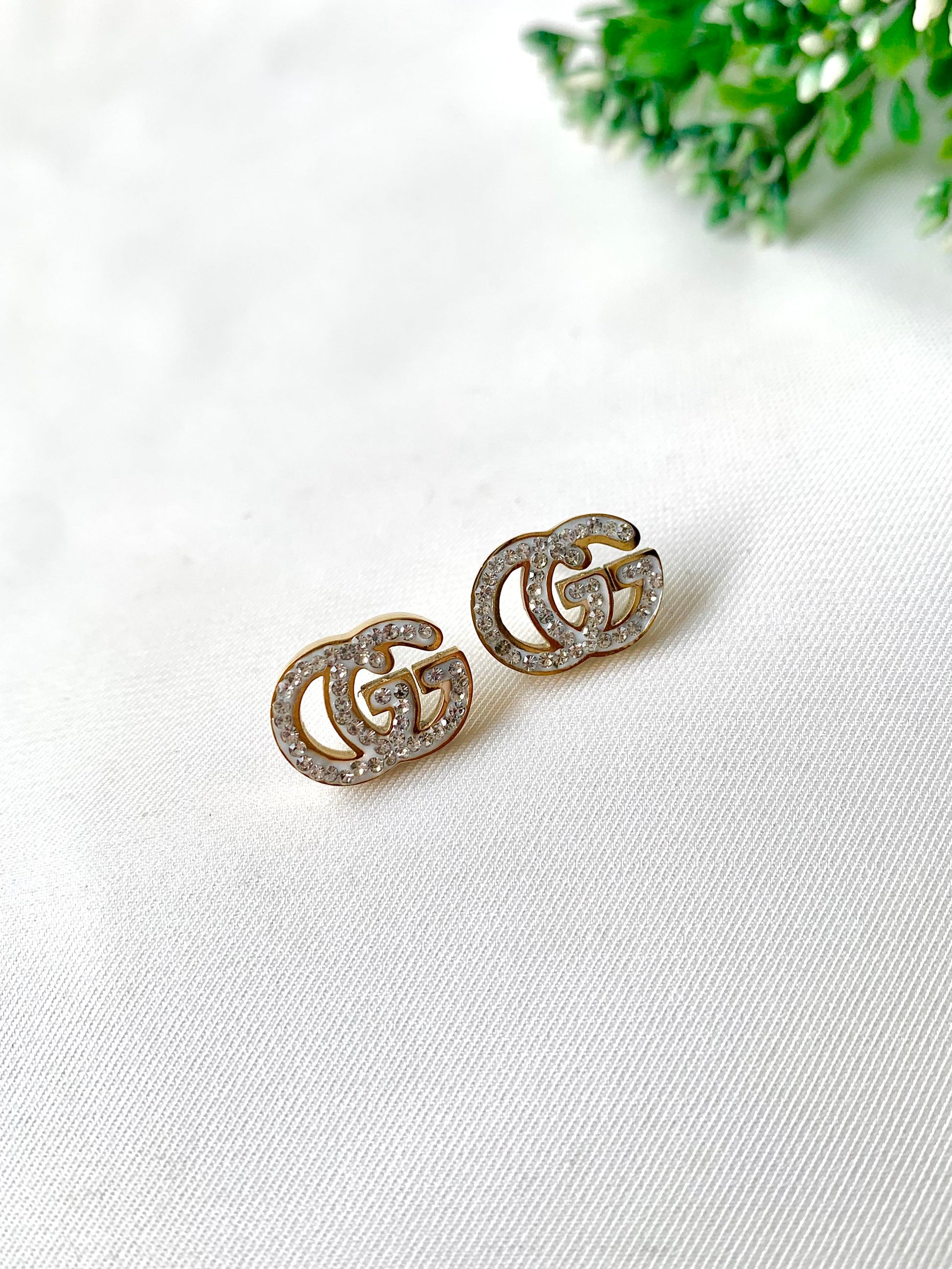 Gleia crystal gold studs with double-G design, 22K gold plated on 316L stainless steel by Zamal Jewels.